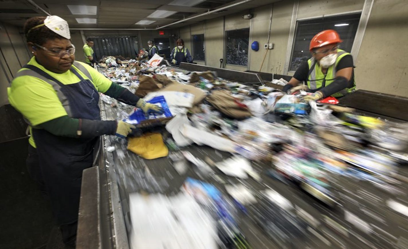 Josefa Calleja, left, and Cecilia Morales worked on the presort line at the Eureka Recycling facility in Minneapolis, pulling nonrecyclables from the raw intake.