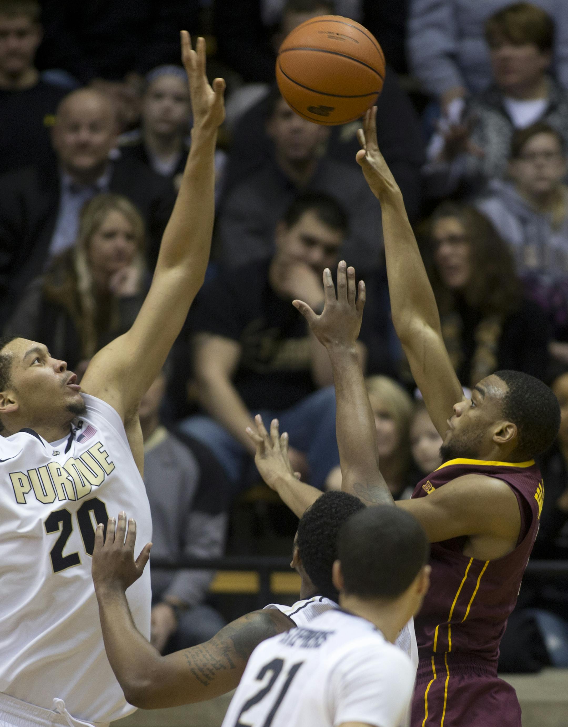 Purdue's A.J. Hammons, left, blocks a shot by Minnesota's Andre Hollins during an NCAA college basketball game Wednesday, Feb. 5, 2014, at Mackey Arena in West Lafayette, Ind. (AP Photo/Journal & Courier, Michael Heinz) NO SALES