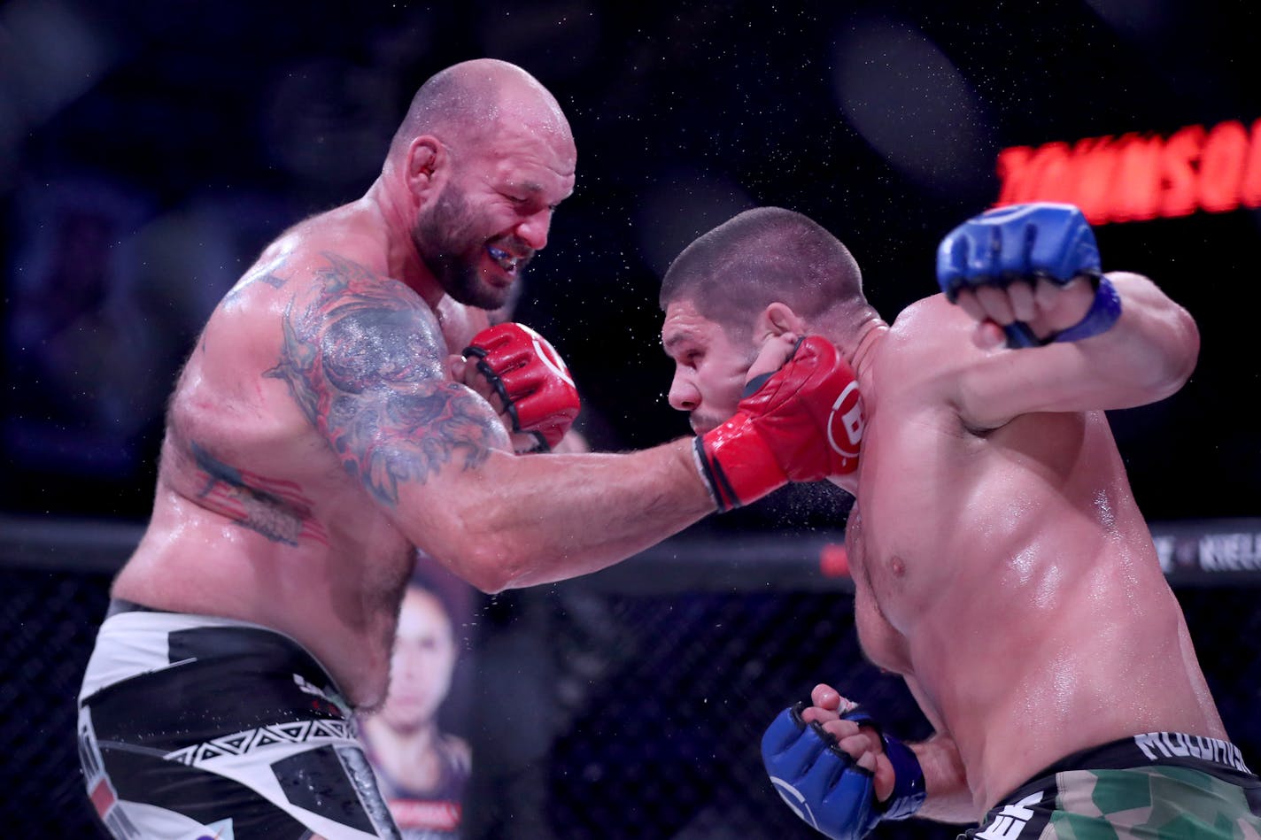 Valentin Moldavsky, right, exchanges blows with Tim Johnson during their Bellator 261 mixed martial arts interim heavyweight title bout Friday, June 25, 2021, in Uncasville, CT. Moldavsky won via decision. (AP Photo/Gregory Payan)