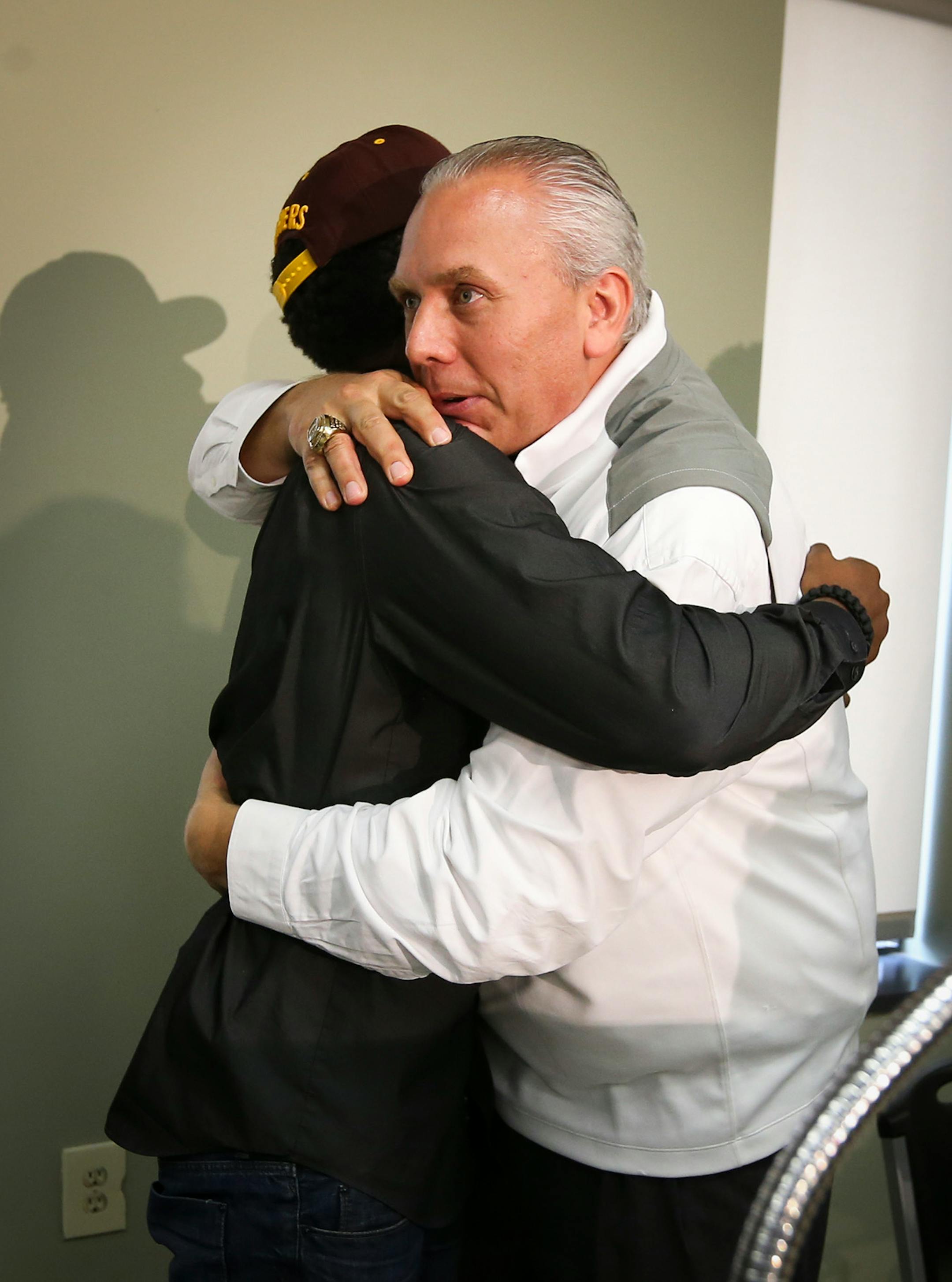 Jarvis Johnson, DeLaSalle basketball star, hugged his coach Dave Thorson, after he announced his college choice of the University of Minnesota at DeLaSalle High School on Friday, Sept. 12, 2014, in Minneapolis, Minn. RENEE JONES SCHNEIDER • reneejones@startribune.com