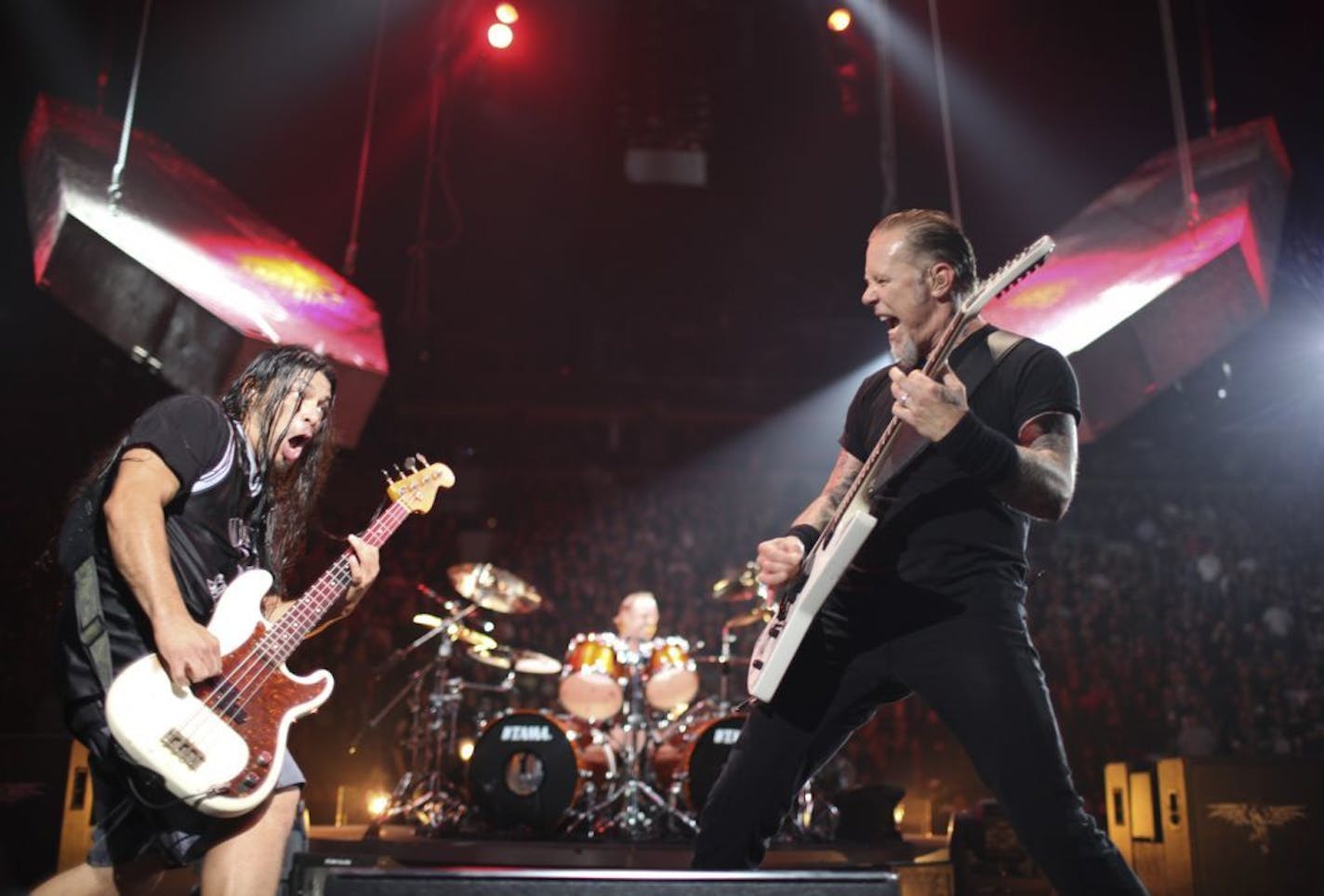 Metallica bassist Rob Trujillo, left, and guitarist James Hetfield squared off during their Target Center show Tuesday night.