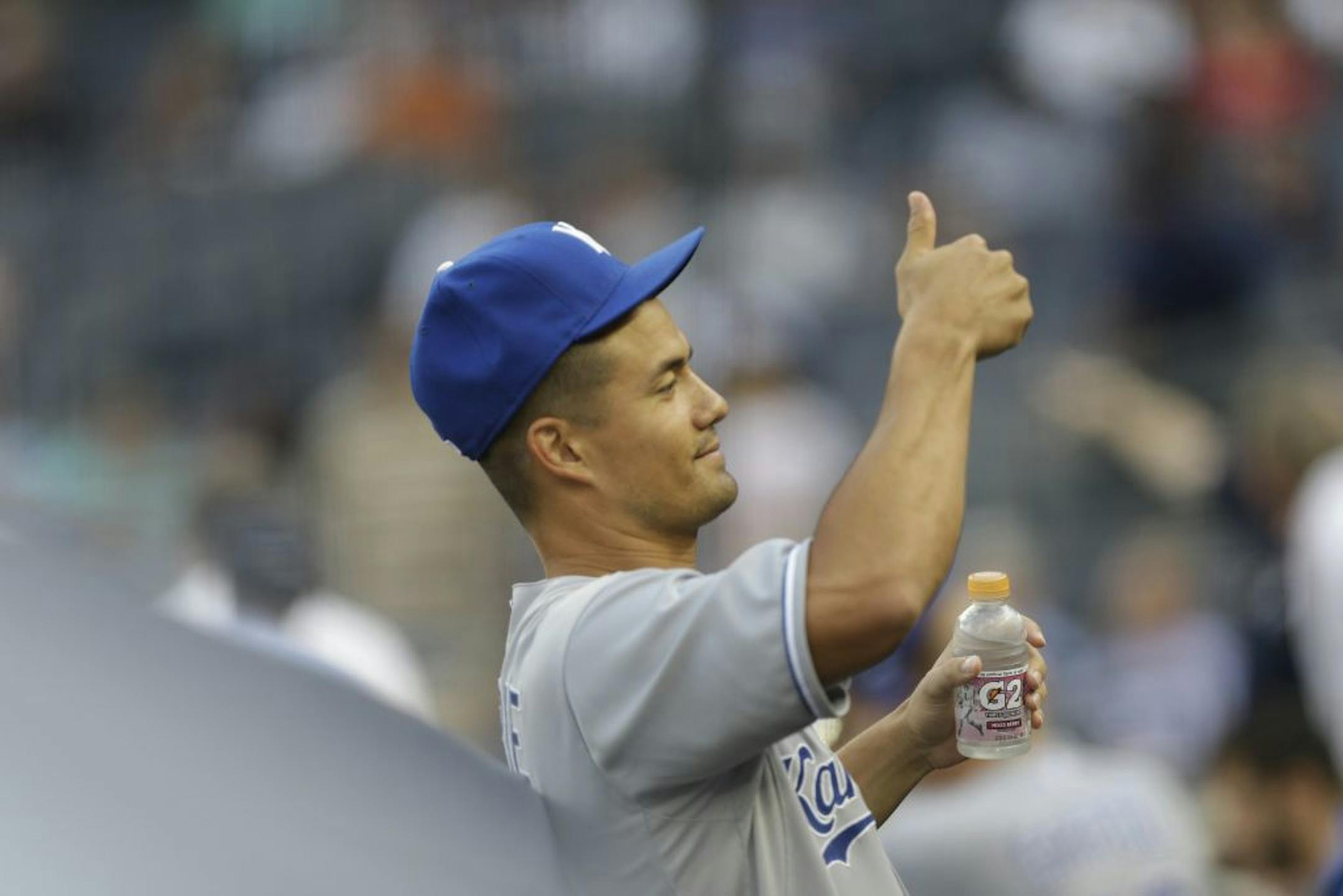 Kansas City Royals starting pitcher Jeremy Guthrie (11) shows thumbs up from the dugout before a baseball game against the New York Yankees, Tuesday, July 9, 2013, in New York.