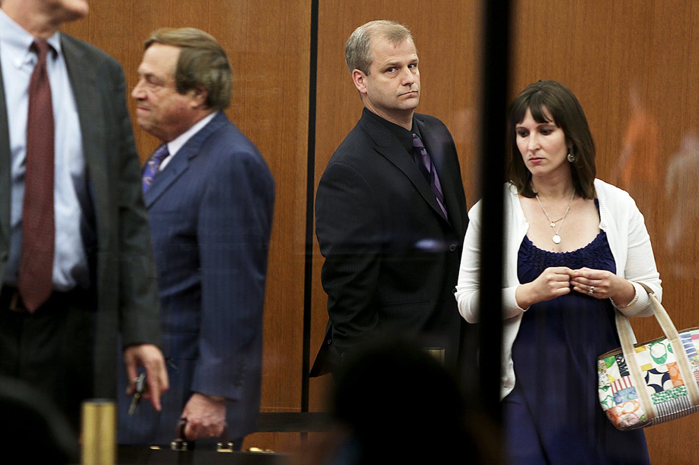 Jonathan Markle, center made his way into the Hennepin County Government Center, Tuesday, June 25, 2013 in Minneapolis, MN. Markle the father who was legally drunk when his car went through the Lake Minnetonka ice last winter, killing his 8-month old daughter, returned to court in a motion hearing where his attorney Joe Friedberg, left, argued to suppress blood test results using a recent Supreme Court decision.