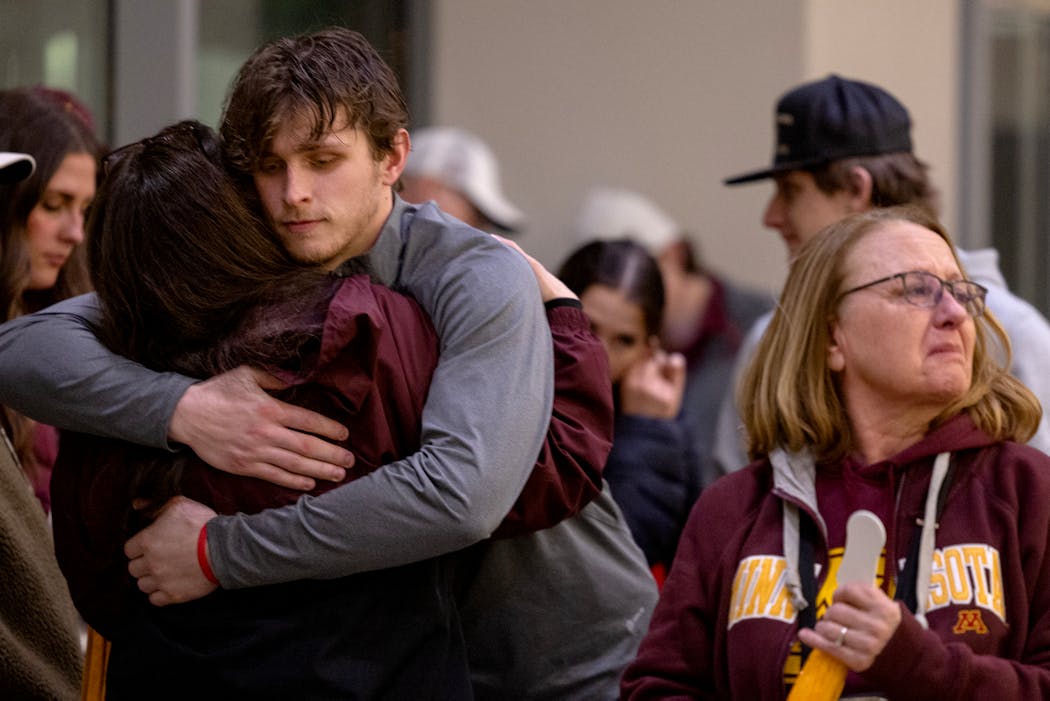 Jaxon Nelson gets a hug from his aunt, Susan Nelson-Bullerman, after hugging his grandmother, Jane Nelson (right), after the Gophers season came to an end in Sioux Falls. 