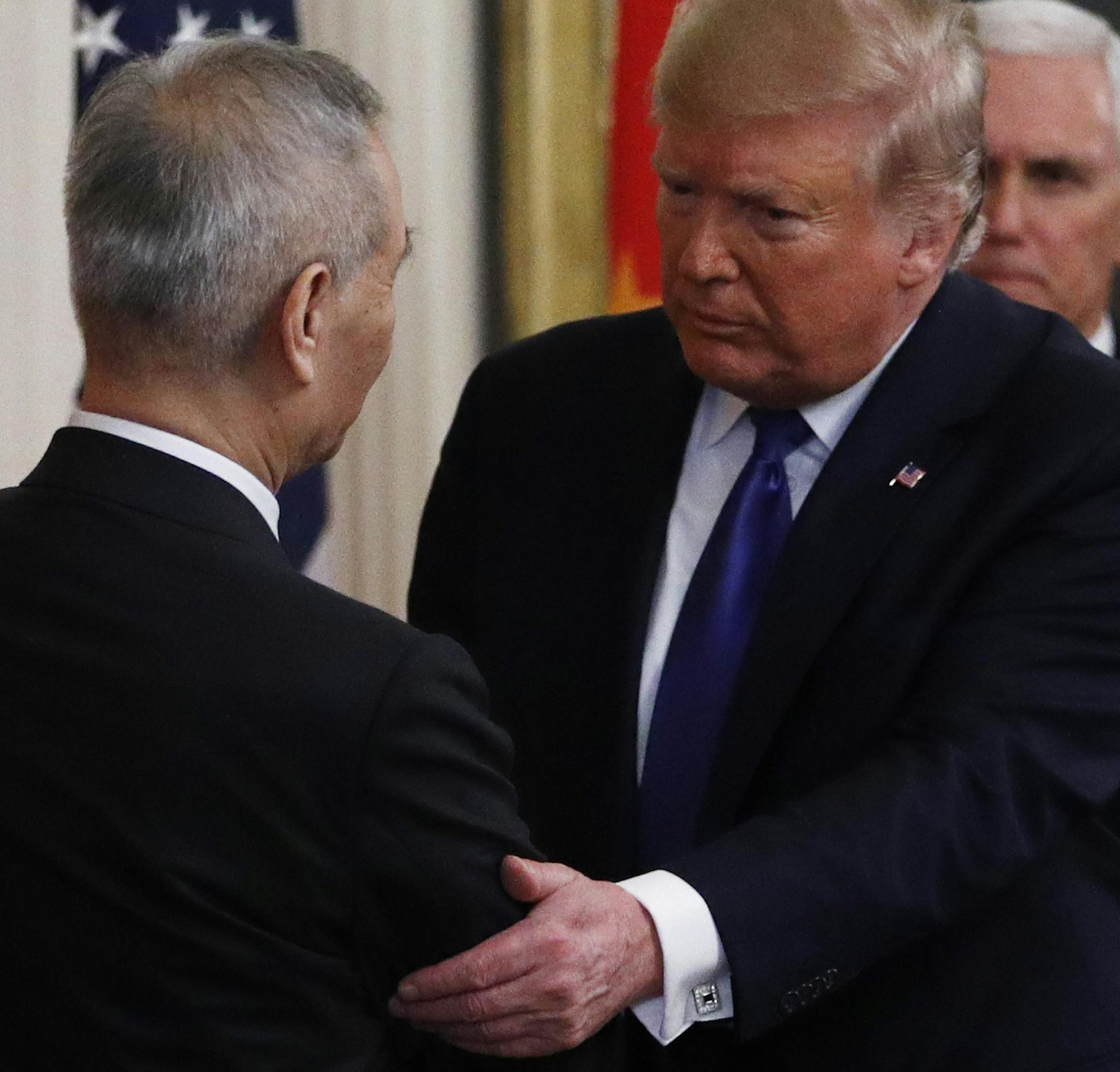 President Donald Trump, right, shakes the hand of Chinese Vice Premier Liu He as they prepare to sign "phase one" of a US China trade agreement, in the East Room of the White House, Wednesday, Jan. 15, 2020, in Washington. (AP Photo/Steve Helber) ORG XMIT: DCSH111