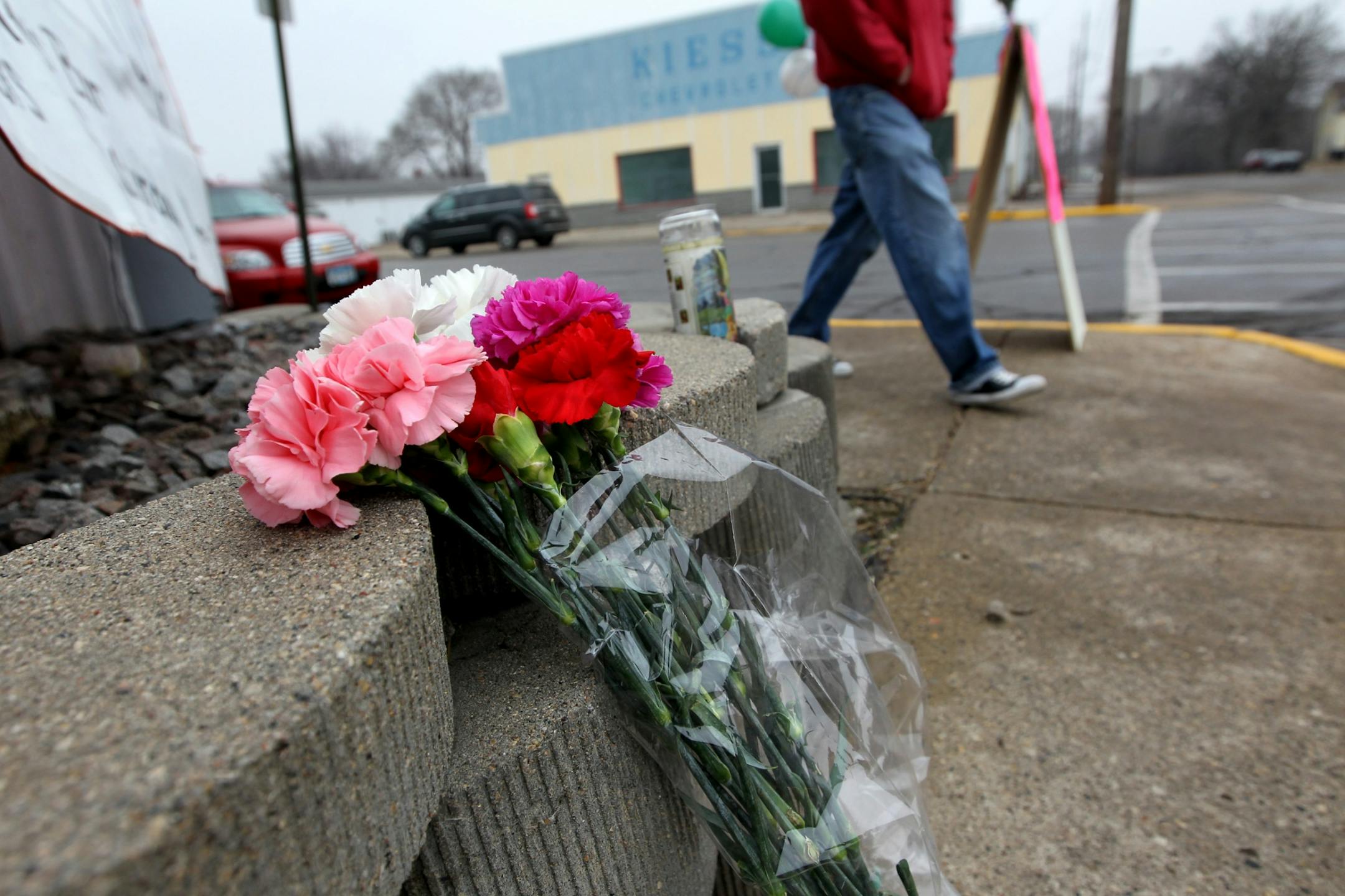 Flowers and a candle sit in a memorial to fallen officer Tom Decker at the corner of Main Street and Second Avenue South in Cold Spring December 1, 2012.