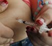 FILE - In this April 29, 2012 file photo, a woman diagnosed with diabetes gives herself an injection of insulin at her home in the Los Angeles suburb 