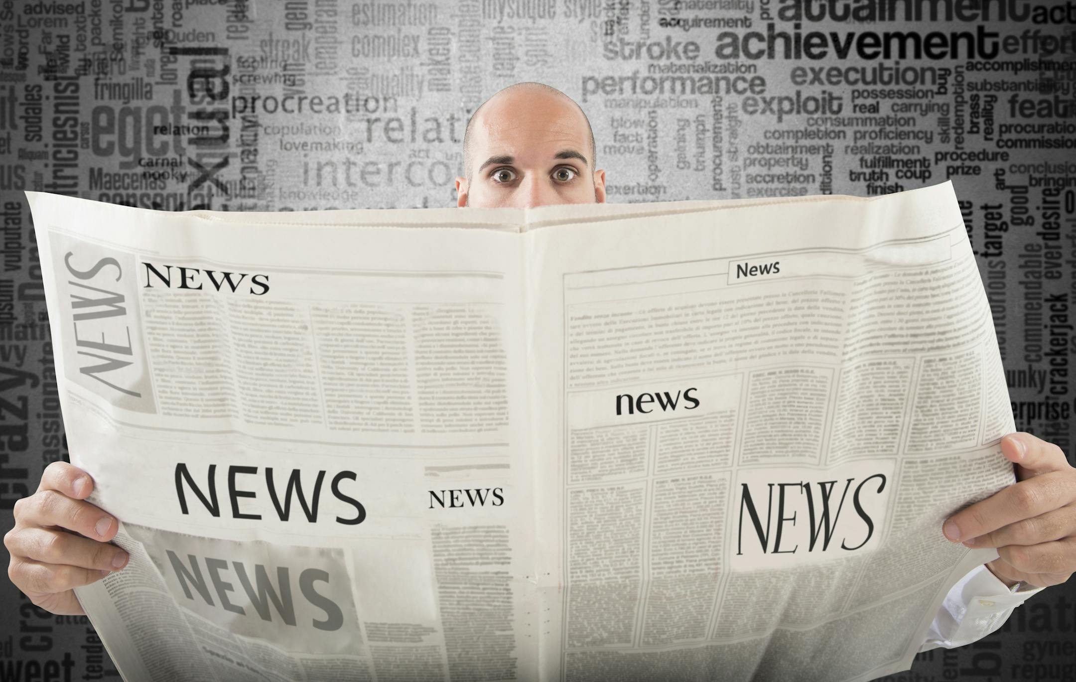 Man with startled expression reading a newspaper