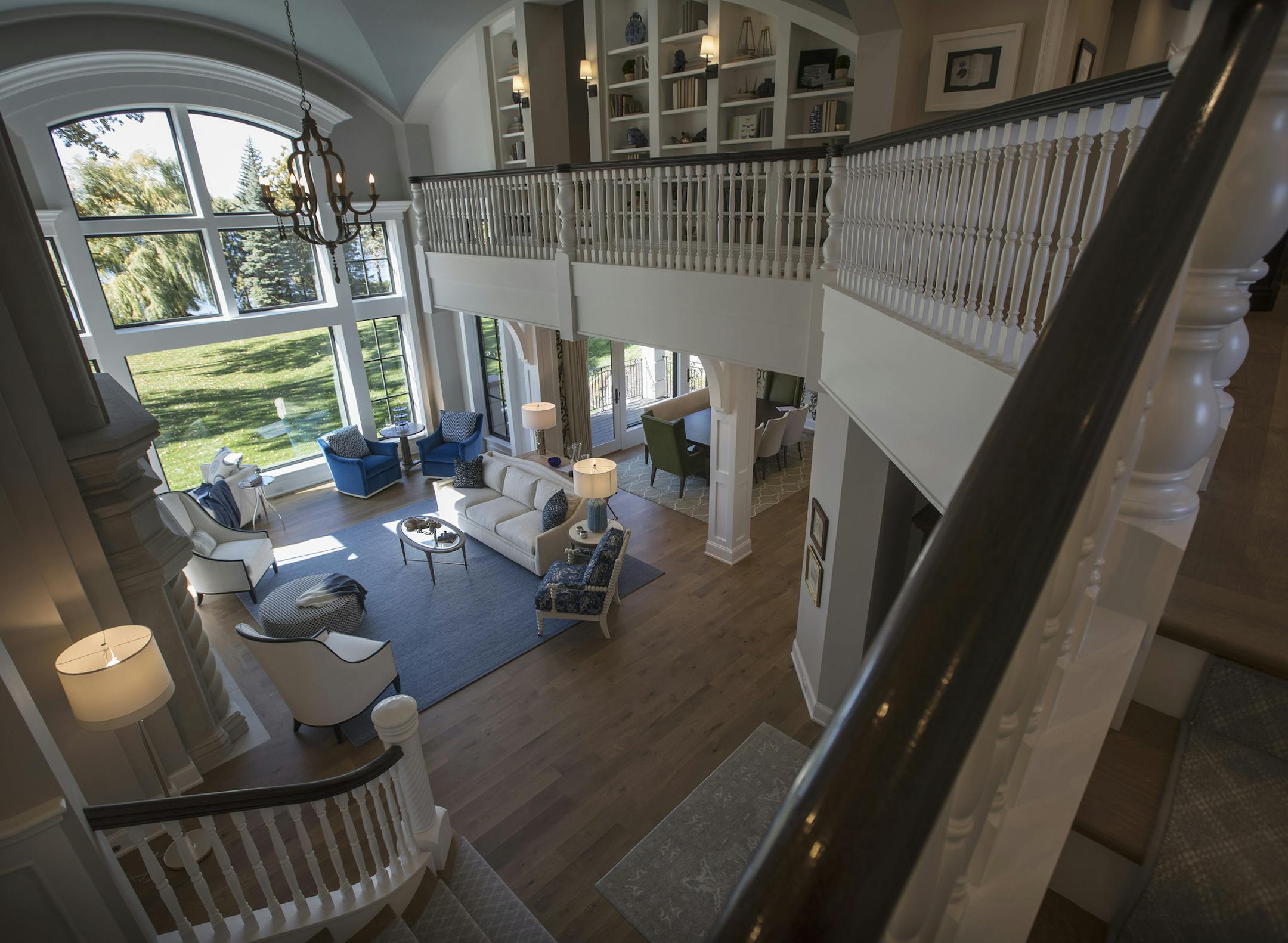 The view from the grand staircase down into the great room. Its blue-and-white color scheme was inspired by the water of its Lake Minnetonka setting.
