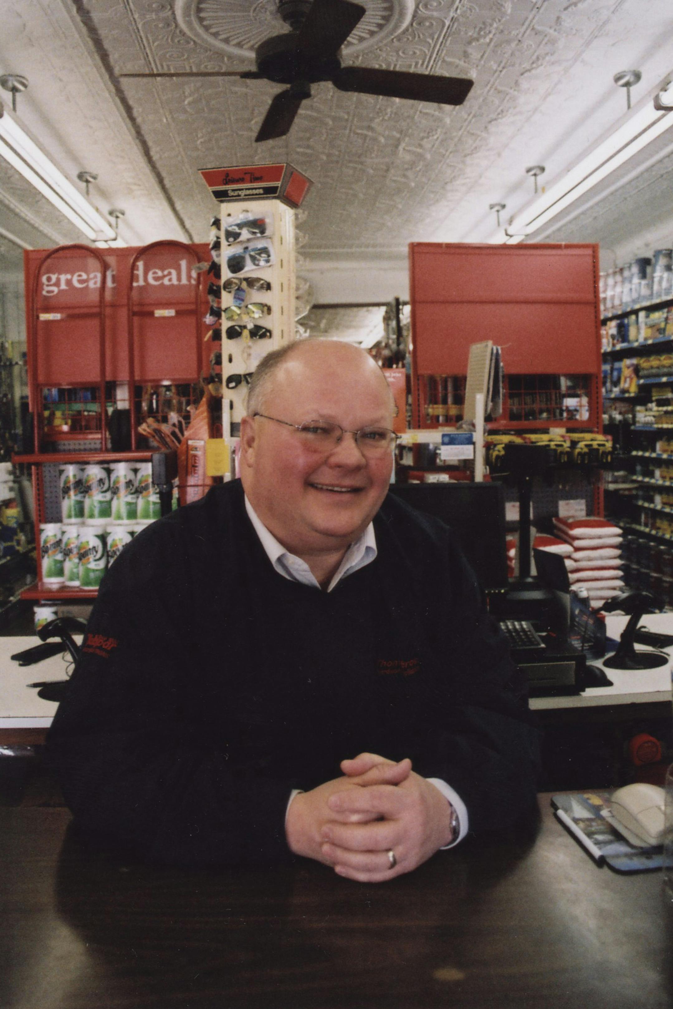 Dick Thomes stood in the section of his hardware store where his great-grand­father started the business in 1888. The tin ceiling is original to the store.