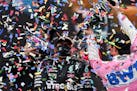 Second-place Racing Point driver Sergio Perez of Mexico, right, poured champagne on winner Mercedes driver Lewis Hamilton of Britain on the podium of 