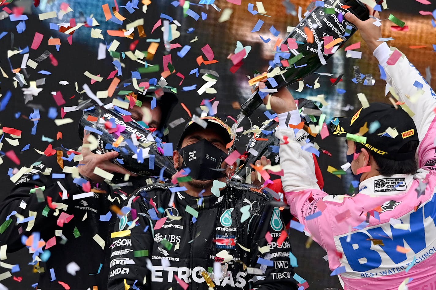 Second-place Racing Point driver Sergio Perez of Mexico, right, poured champagne on winner Mercedes driver Lewis Hamilton of Britain on the podium of the Formula One Turkish Grand Prix at the Istanbul Park circuit racetrack in Istanbul on Sunday.