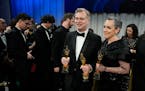 Christopher Nolan, winner of the awards for best director and best picture for "Oppenheimer," left, and Emma Thomas, winner of the award for best pict