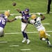 Minnesota Vikings quarterback Kirk Cousins (8) threw an incomplete pass as Green Bay Packers linebacker Za'Darius Smith applied pressure.