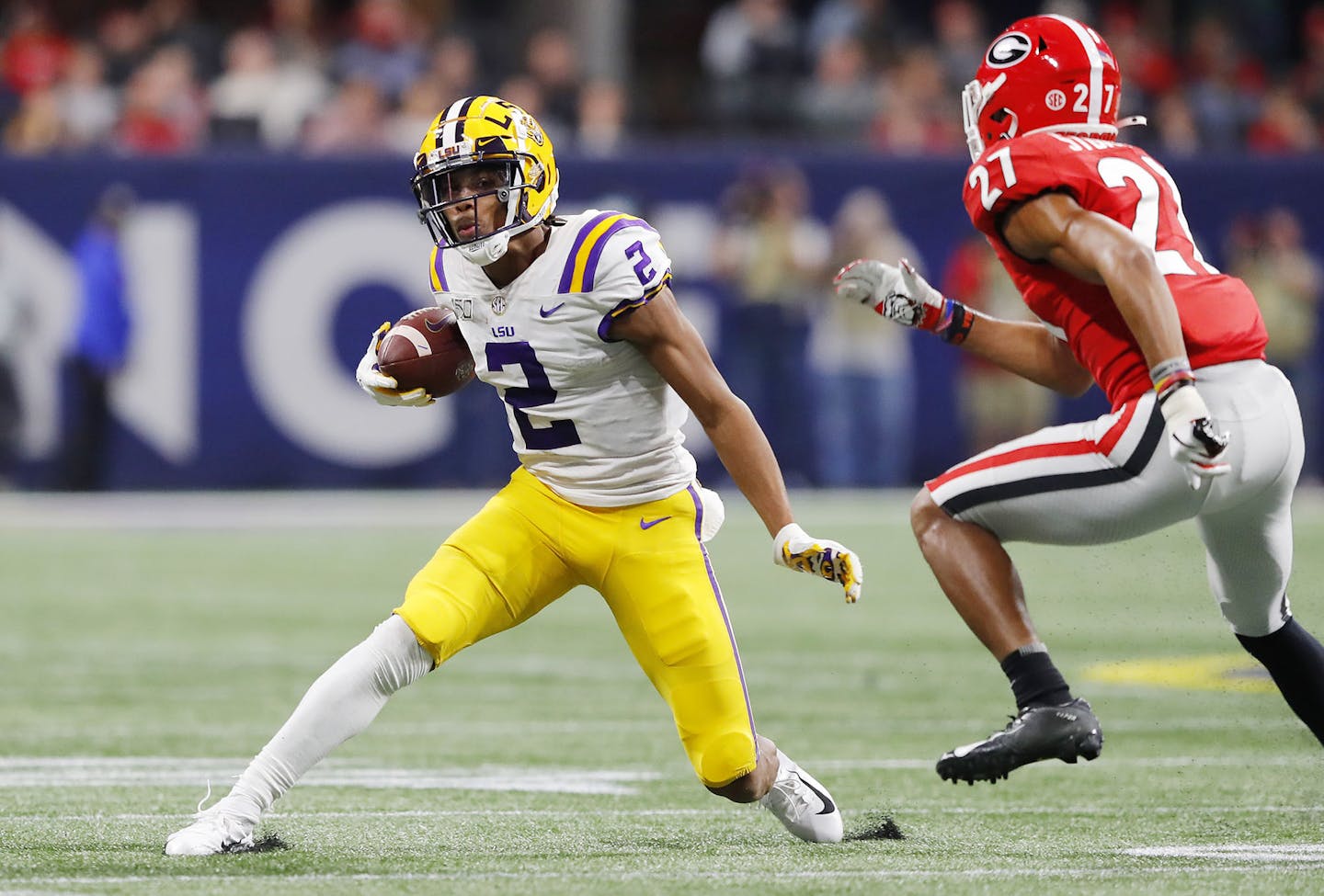 LSU wide receiver Justin Jefferson (2) runs with the ball as Georgia's Eric Stokes (27) looks to make the tackle during the SEC Championship game at Mercedes-Benz Stadium in Atlanta on December 7, 2019. (Kevin C. Cox/Getty Images/TNS) ORG XMIT: 1627304