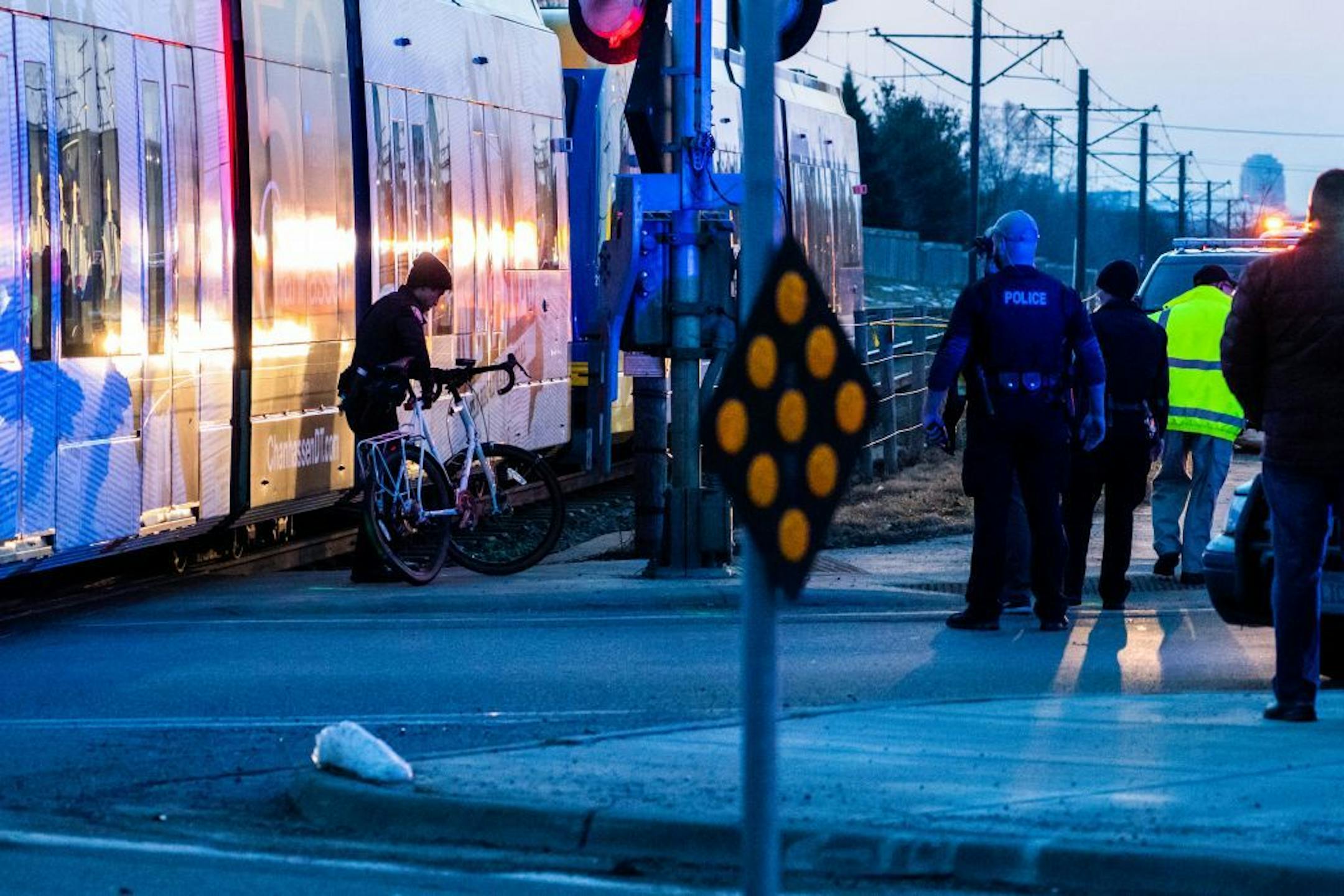 An officer removed a damaged bicycle from the scene.