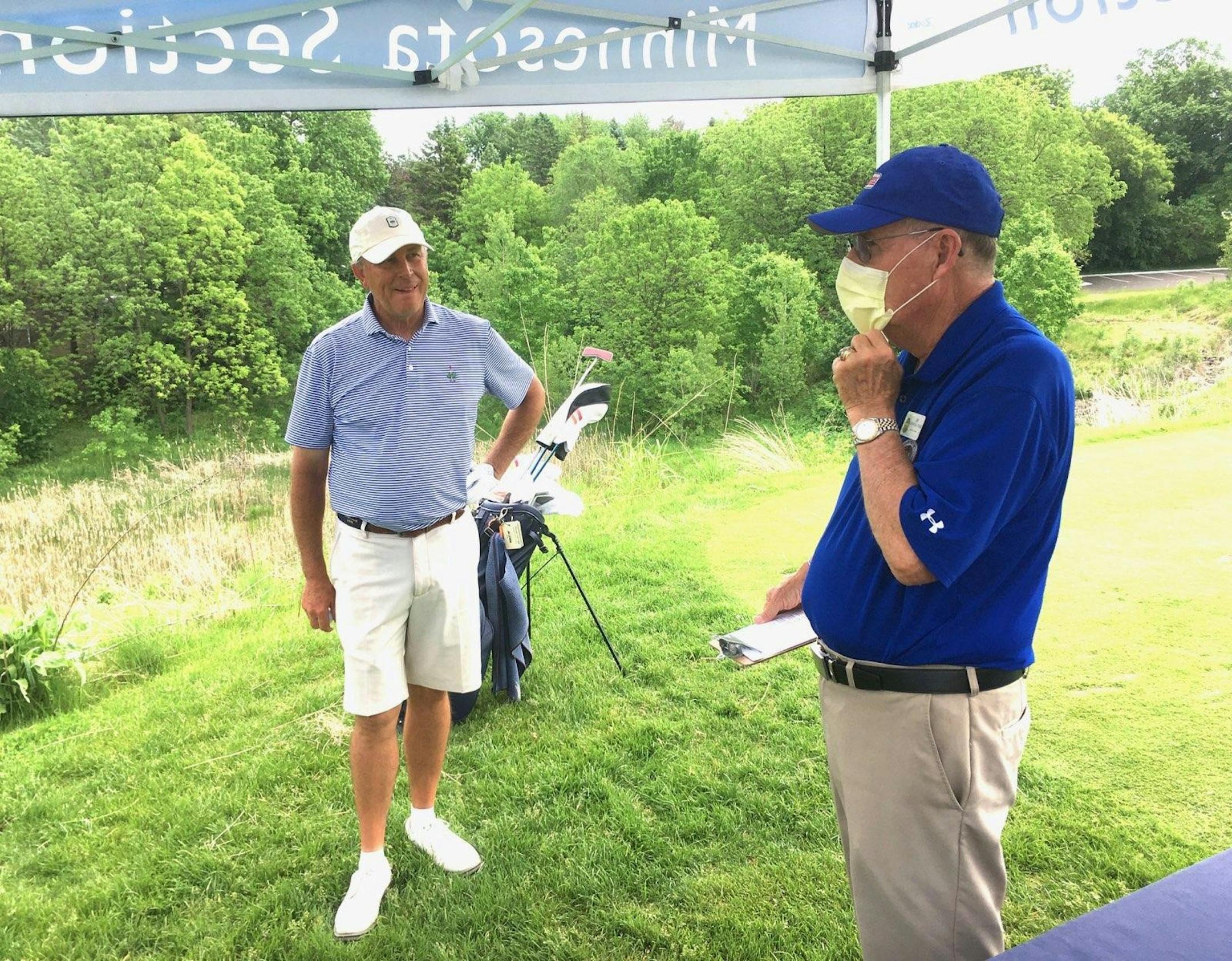 Pro golf agent Jim Lehman, left, talked with PGA of America Minnesota section rules official Jim Manthis before Lehman’s first round at the PGA Minnesota Senior Open on Tuesday at Keller Golf Course.