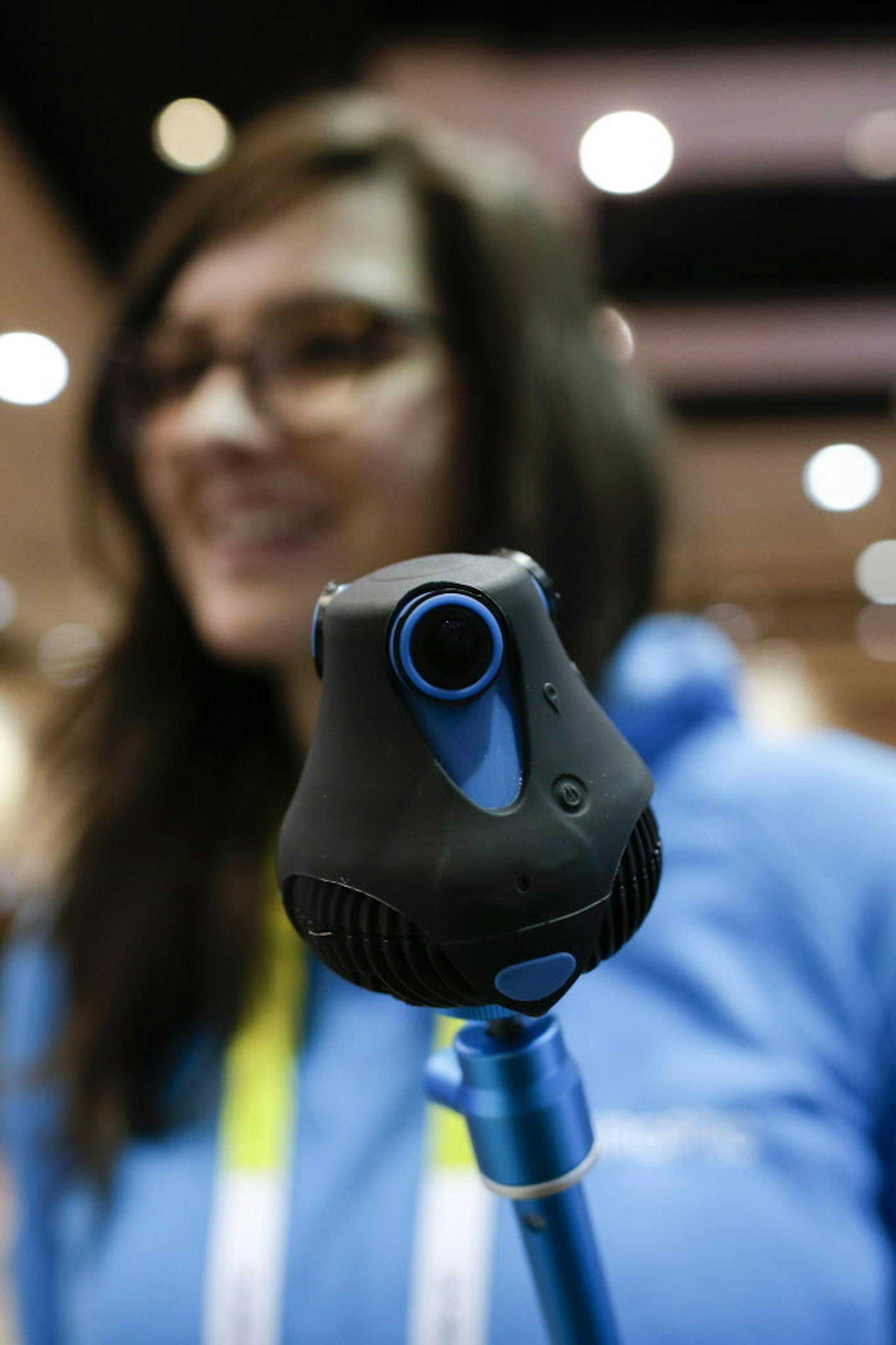 A woman holds the 360cam from Giropitc at CES Unveiled, a media preview event for CES International, Monday, Jan. 4, 2016, in Las Vegas. The camera makes full spherical videos and photos. (AP Photo/Gregory Bull)