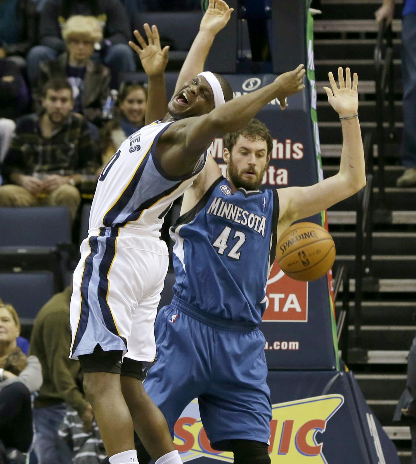 Memphis Grizzlies' Zach Randolph, left, and Minnesota Timberwolves' Kevin Love (42) go for a rebound in the first half of an NBA basketball game in Memphis, Tenn., Sunday, Dec. 15, 2013. (AP Photo/Danny Johnston)