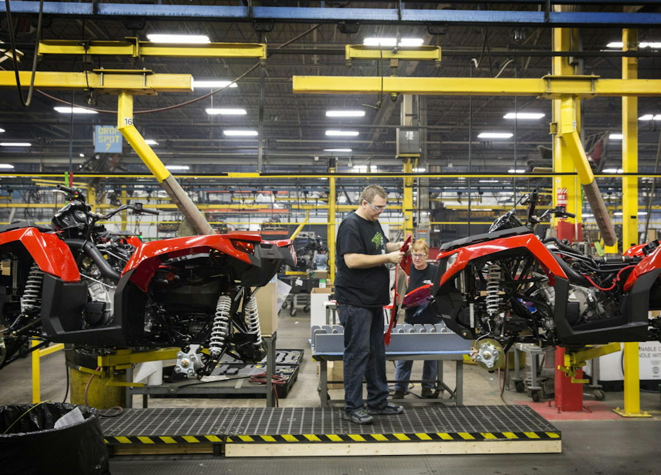 Factory workers assemble 2016 Altera ATVs in the Arctic Cat factory in Thief River Falls on Wednesday, September 30, 2015. ] LEILA NAVIDI leila.navidi@startribune.com / BACKGROUND INFORMATION: Arctic Cat management did not allow the photographer to get any names of the workers.