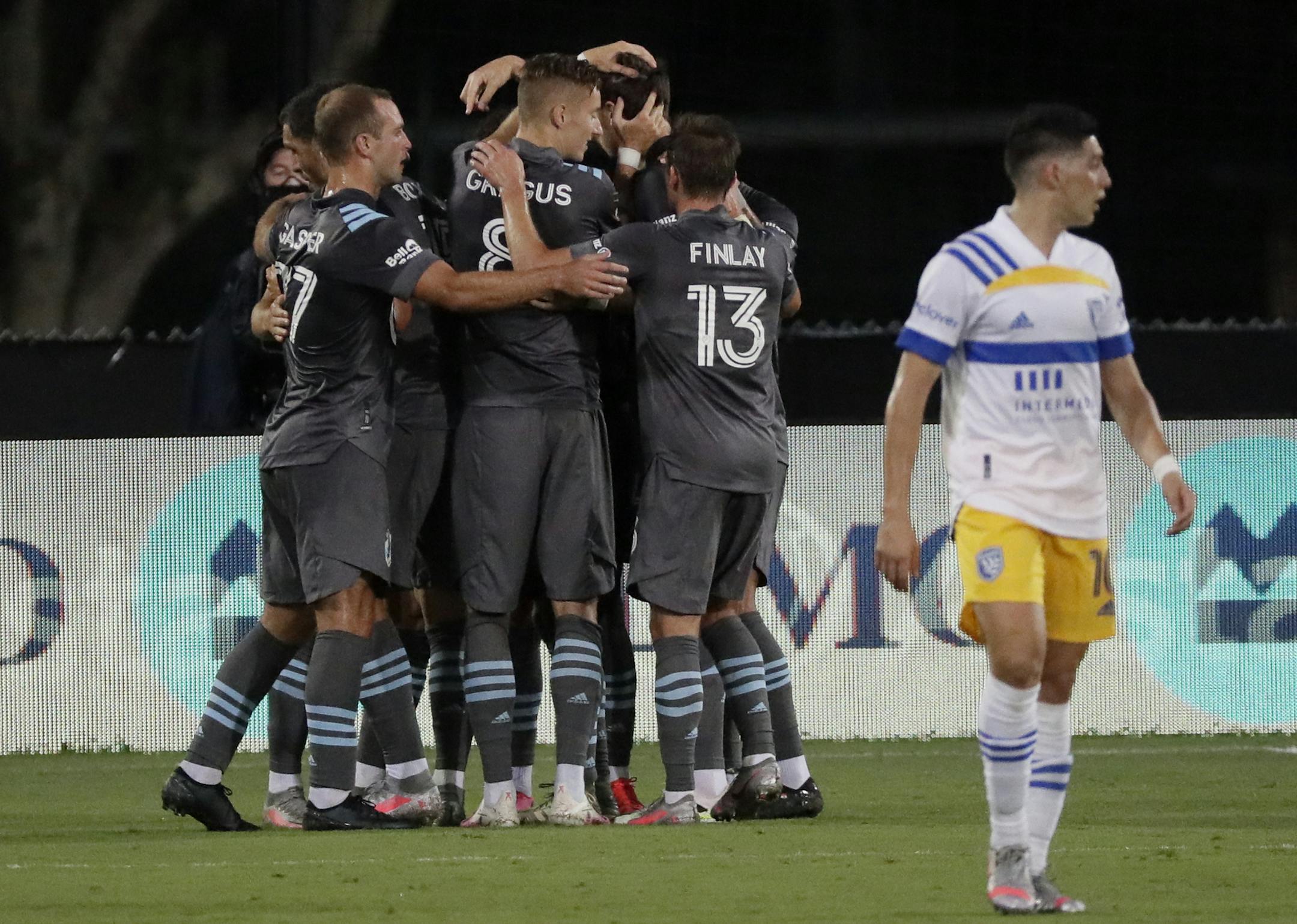 Minnesota United midfielder Robin Lod celebrates his goal as San Jose Earthquakes forward Cristian Espinoza walks off during the first half of an MLS soccer match, Saturday, Aug. 1, 2020, in Kissimmee, Fla. (AP Photo/John Raoux)