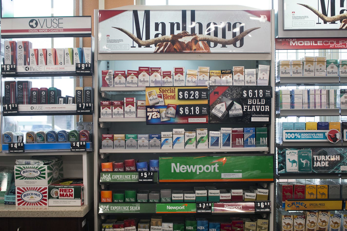 FILE - In this May 18, 2017 file photo, packs of cigarettes are offered for sale at a convenience store in Helena, Mont. A tobacco industry-funded group is asking the Montana Supreme Court to re-phrase a ballot initiative that would raise tobacco taxes to pay for the state's Medicaid expansion and other health programs. The lawsuit filed Monday. Aug. 6, 2018 by Montanans Against Higher Taxes says the ballot statement's wording is incorrect and will cause voter confusion. (AP Photo/Bobby Caina Ca