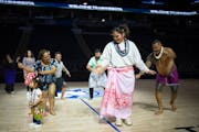 Alissa Pili dances with members of the local Samoan community, including former Minnesota Vikings player, Esera Tuaolo, right, at Target Center. The M