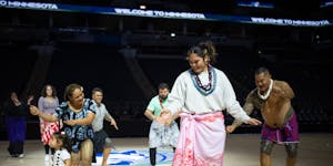 Alissa Pili dances with members of the local Samoan community, including former Minnesota Vikings player, Esera Tuaolo, right, at Target Center. The M