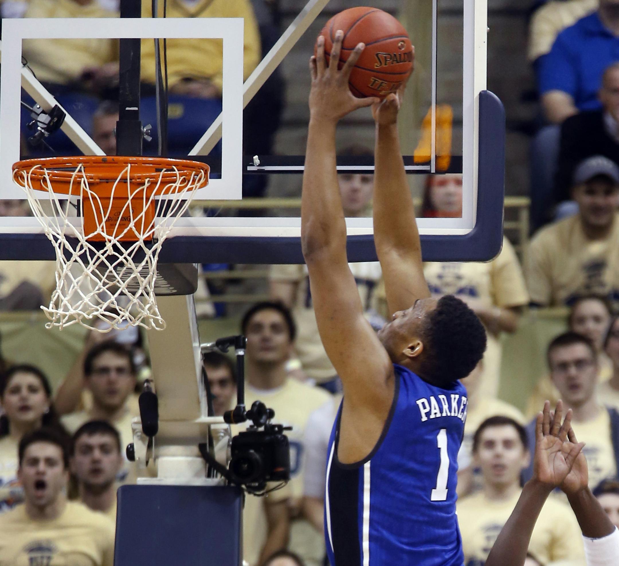 Duke's Jabari Parker (1) goes over Pittsburgh's Talib Zanna (42) for a dunk during the first half of an NCAA college basketball game on Monday, Jan. 27, 2014, in Pittsburgh. (AP Photo/Keith Srakocic)