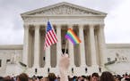 The crowd celebrates outside of the Supreme Court in Washington, Friday June 26, 2015, after the court declared that same-sex couples have a right to 