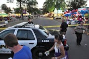 Police adjust crime scene tape at the intersection of Dan Patch Ave and Cooper St. at the State Fair where a knife stabbing incident occurred Sunday e