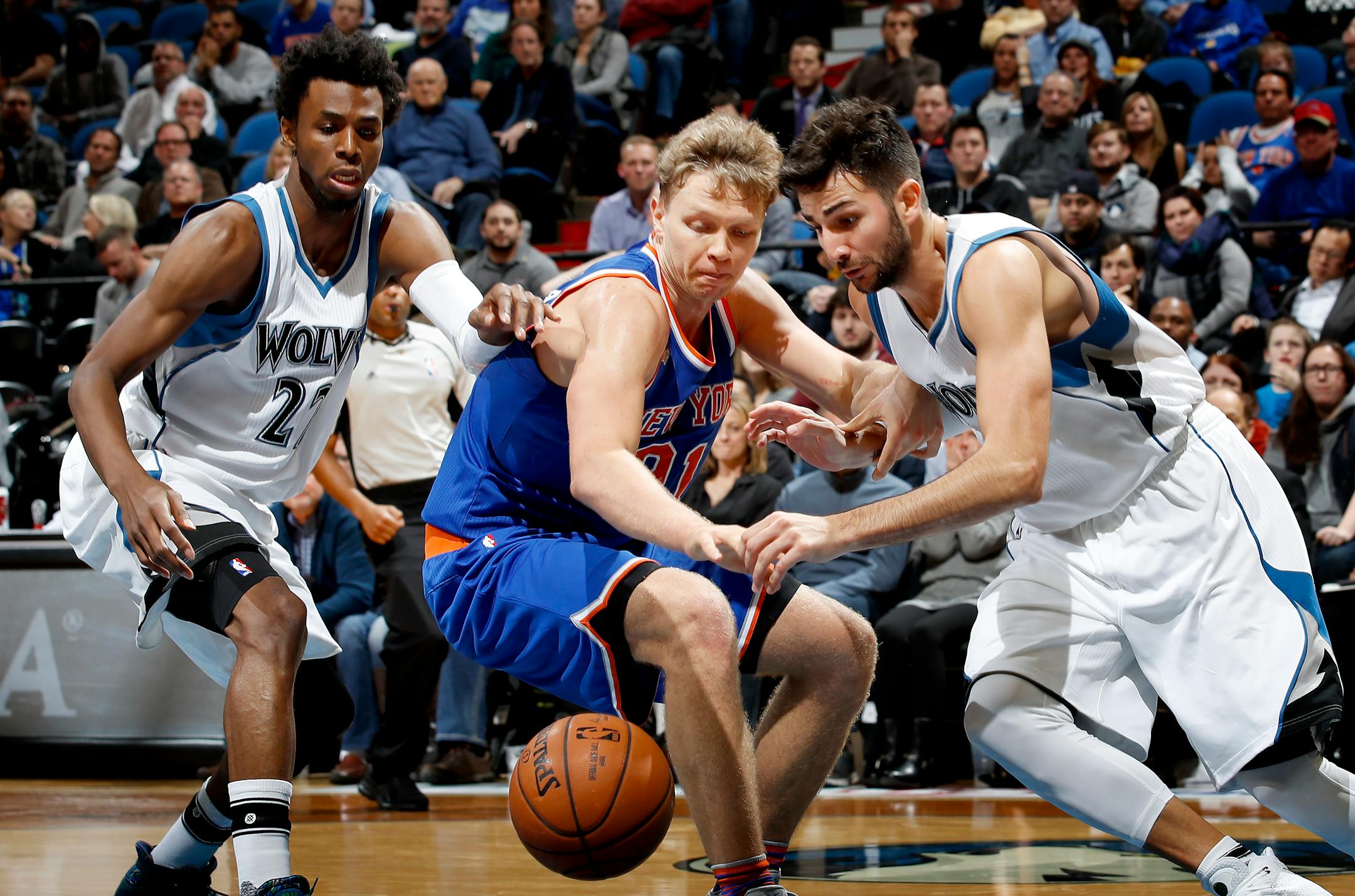 Andrew Wiggins (22) and Ricky Rubio (9) fought for a loose ball with Mindaugas Kuzminskas (91) in the fourth quarter. ] CARLOS GONZALEZ cgonzalez@startribune.com - November 30, 2016, Minneapolis, MN, Target Center, NBA, Minnesota Timberwolves vs. New York Knicks