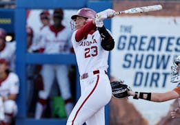 Oklahoma's Tiare Jennings watches her home run against Texas during the first inning of Game 1 of the Women's College World Series championship series