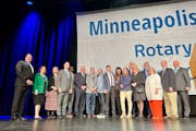 Local officials posed for a photo after the announcement that Rotary International will host its annual international convention in Minneapolis in 202