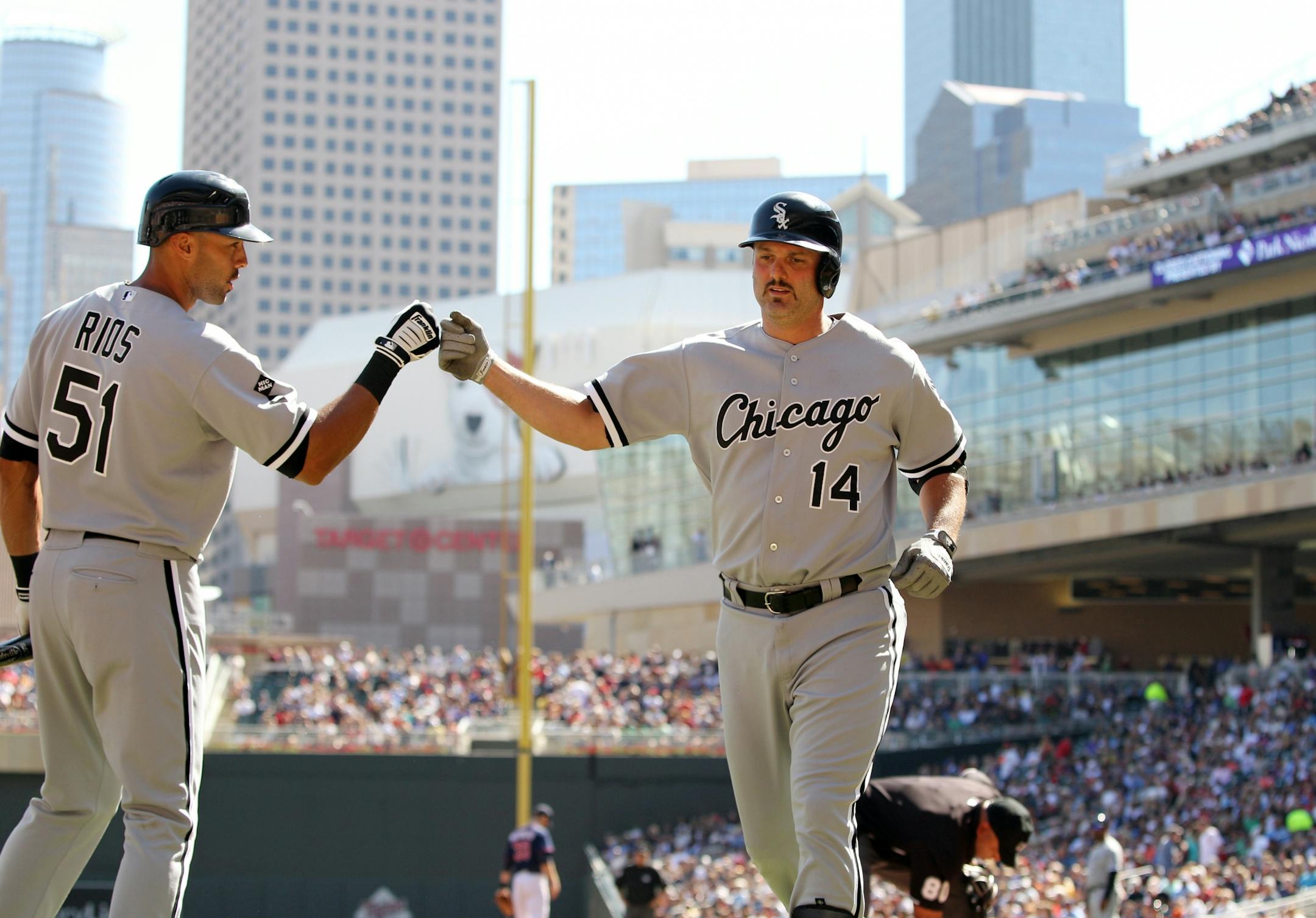 Chicago White Sox's Paul Konerko (14) is congratulated by teammate Alex Rios (51) after hitting a two-run home run against Minnesota Twins starting pitcher Samuel Deduno during the third inning of a baseball game, Saturday, Sept. 15, 2012, in Minneapolis.