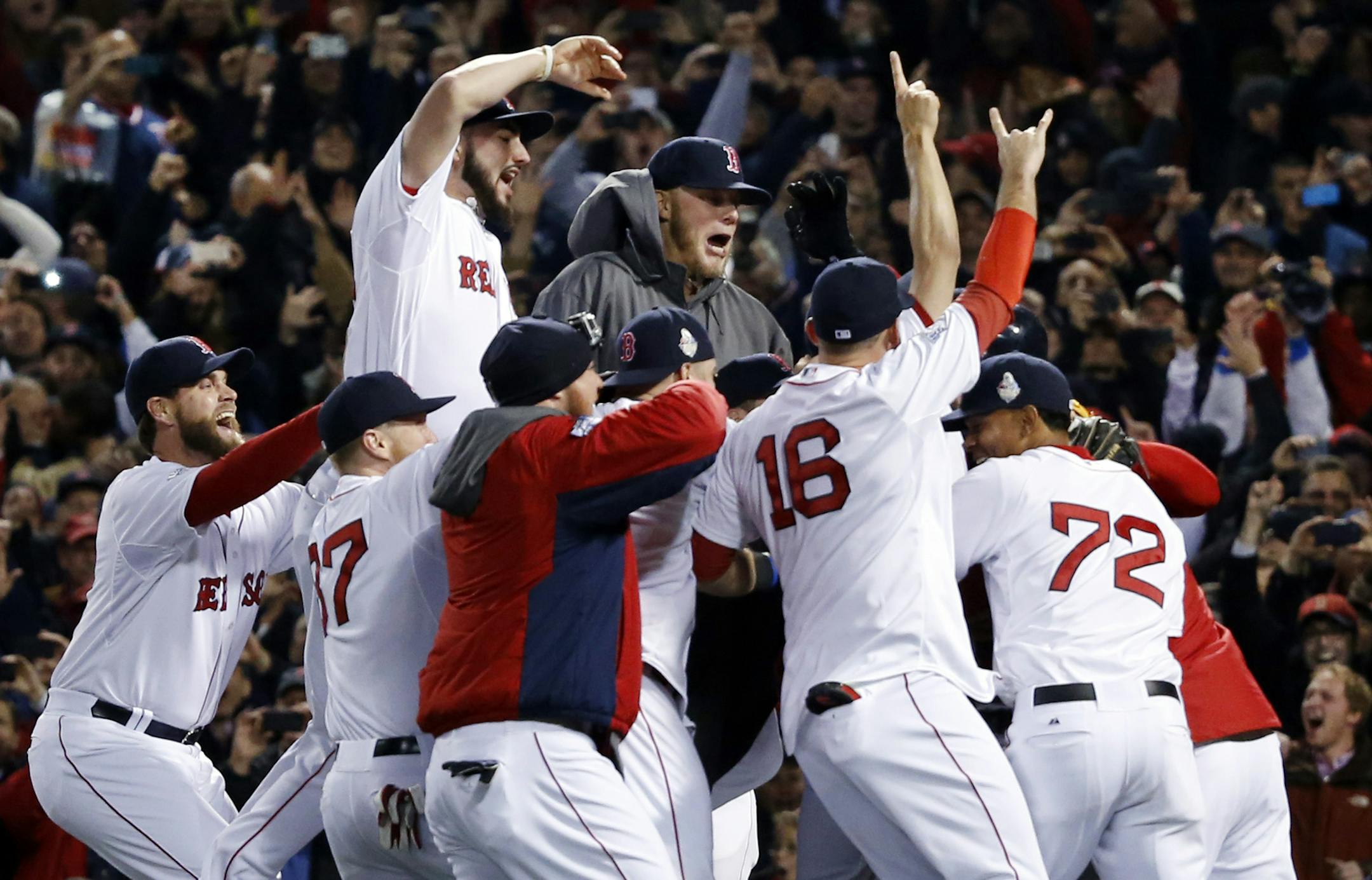Boston Red Sox players celebrate on the field after they defeated the St. Louis Cardinals 6-1 in Game 6 of baseball's World Series, Wednesday, Oct. 30, 2013, at Fenway Park in Boston. (AP Photo/Elise Amendola)