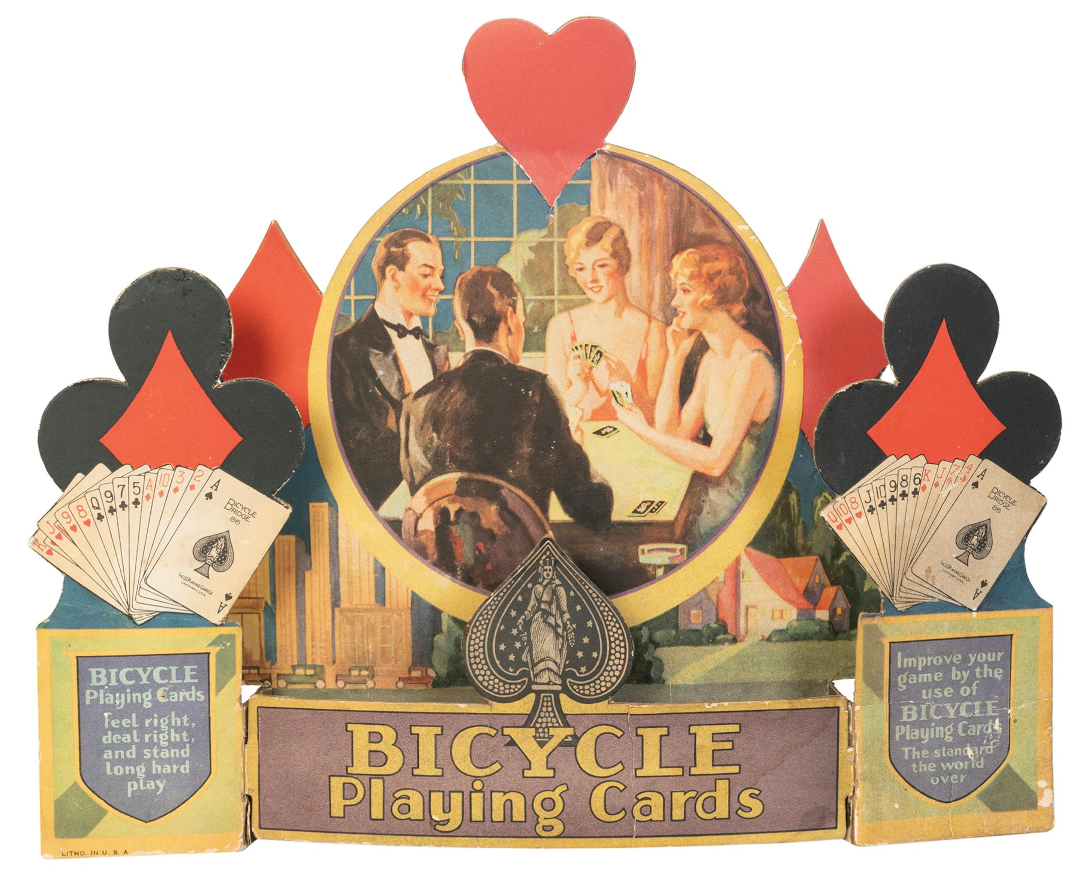 When advertisements include pictures of people, their clothing and hairstyles can help date the item. This store display for Bicycle Playing Cards is from about 1930.