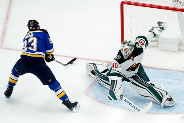 St. Louis Blues' Dmitrij Jaskin, of Russia, scores past Minnesota Wild goalie Devan Dubnyk, right, during the first period of an NHL hockey game Satur