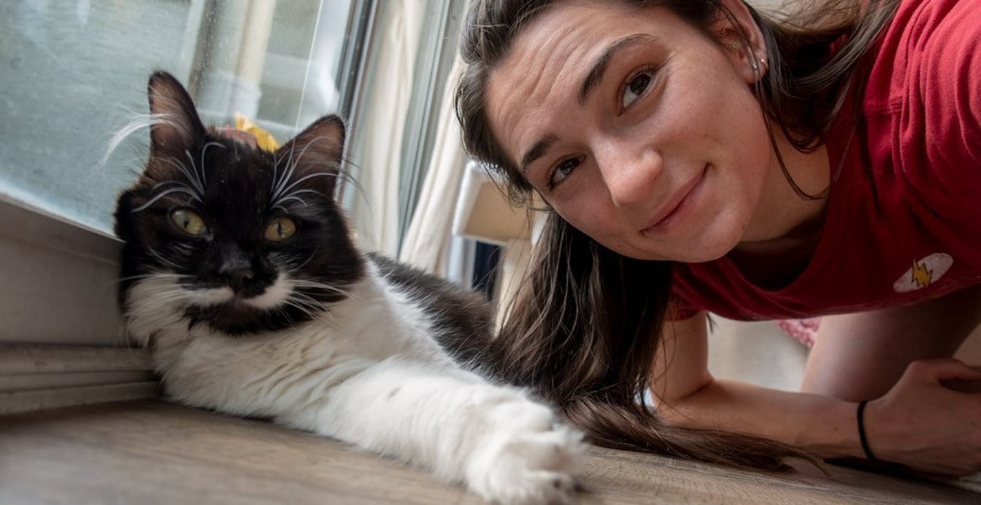 Kyra condie, rock climber from shoreview, with newly adopted cats Pika (the Siamese) and