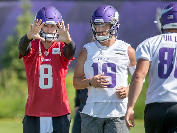 Vikings quarterback Kirk Cousins (8), standing next to receiver Adam Thielen, worked on play-action passes a lot during Vikings minicamp at the TCO Pe