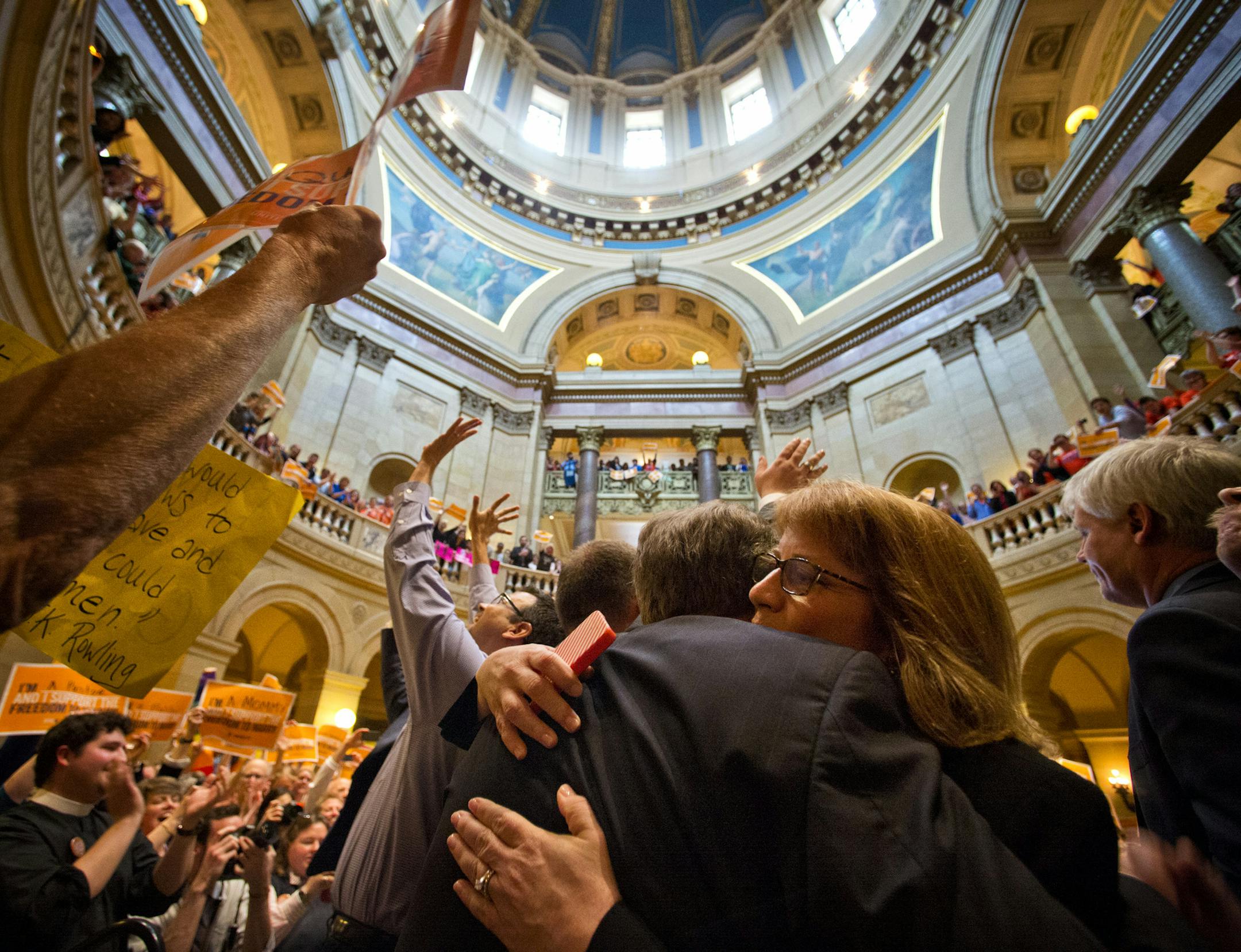In celebration, House Majority Leader Erin Murphy hugged Rep. Steve Simon, who had delivered an emotional speech on the House floor.