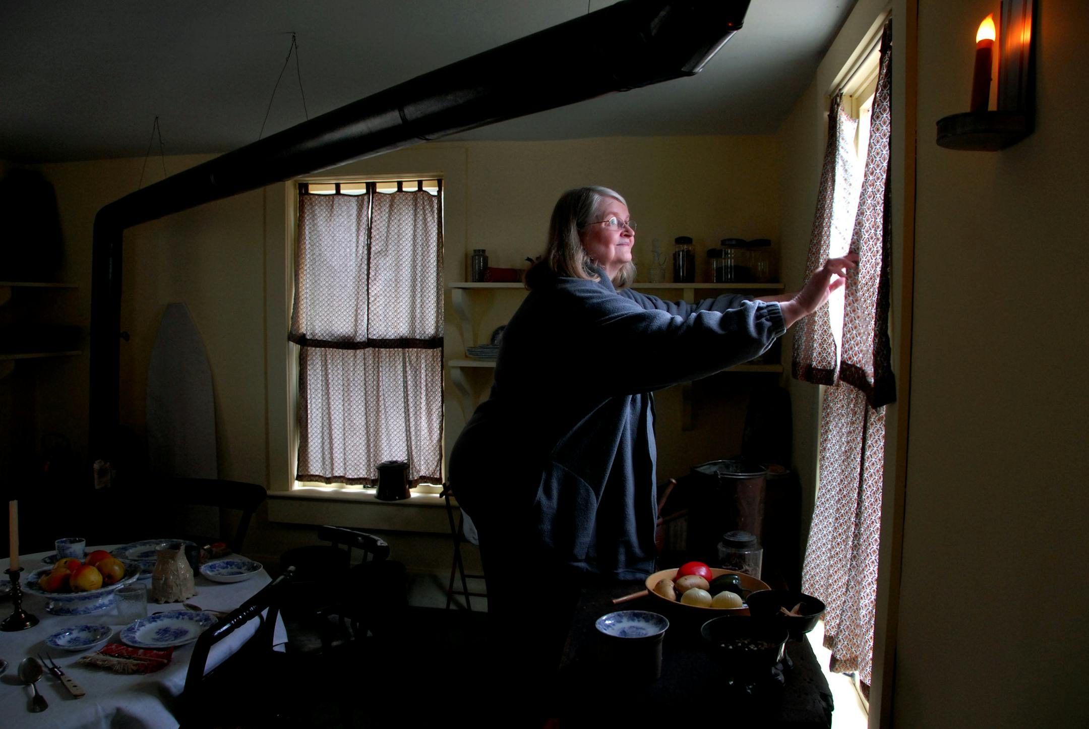 Dorothy von Lehe, executive director of the Mayo House for 35 years, shut the curtains in the kitchen. The stovepipe that ran the length of the room kept the space warm.