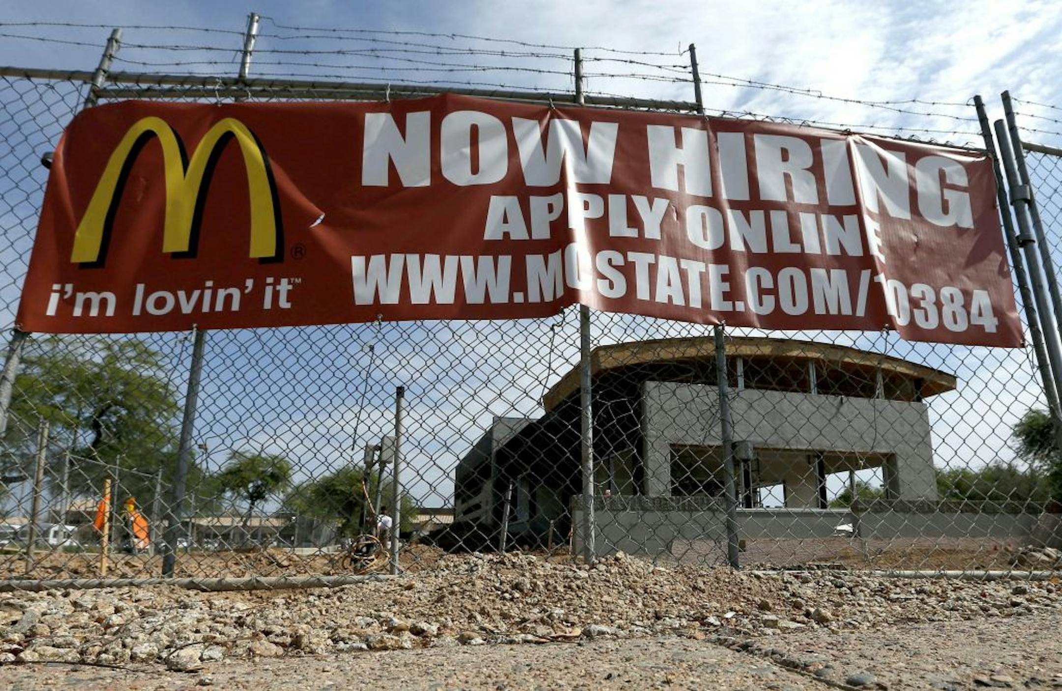 In this Aug. 1, 2013, photo, a "Now Hiring" sign hangs in front of a new McDonald's restaurant under construction in Tempe, Ariz. Of the 162,000 jobs the economy added in July 2013, a disproportionate number were part-time, low-paying or both. Part-time work accounted for more than 65 percent of the positions employers added in July with low-paying retailers, restaurants and bars supplying more than half July�s job gain.