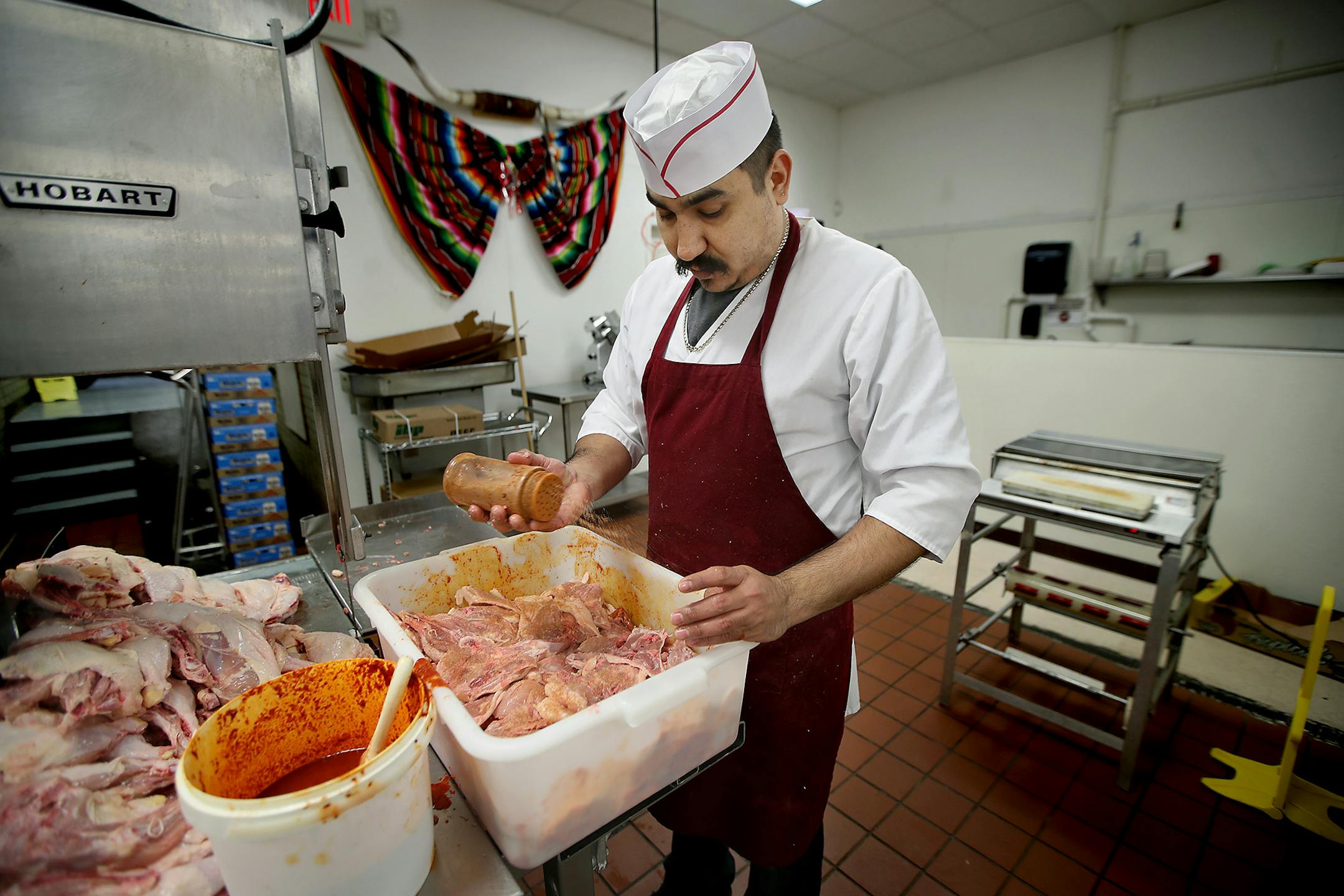 Jose or "Fede," worked his shift at a local market, Thursday, February 23, 2017 in Worthington, MN. He said that his three children are always afraid of coming home from school and not seeing him there.