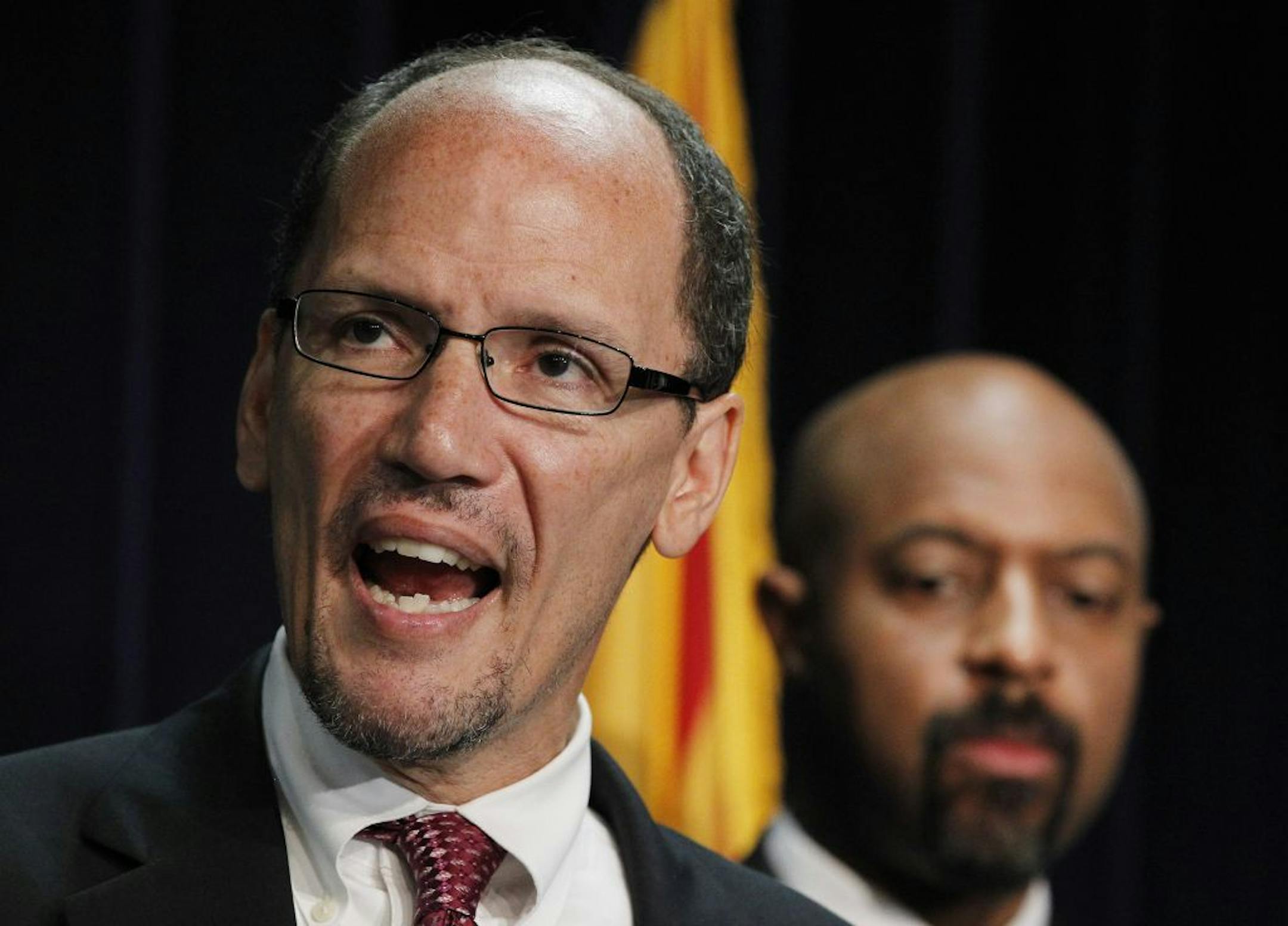 FILE - In this Thursday, May 10, 2012 file photo, United States Assistant Attorney General Thomas Perez, left, who heads up the civil rights division at the Department of Justice, is joined by Deputy Assistant Attorney General for Civil Rights, Roy Austin, as Perez announces a federal civil lawsuit against Maricopa County Sheriff Joe Arpaio during a news conference in Phoenix, after months of negotiations failed to yield an agreement to settle allegations that Arpaio's department racially profil