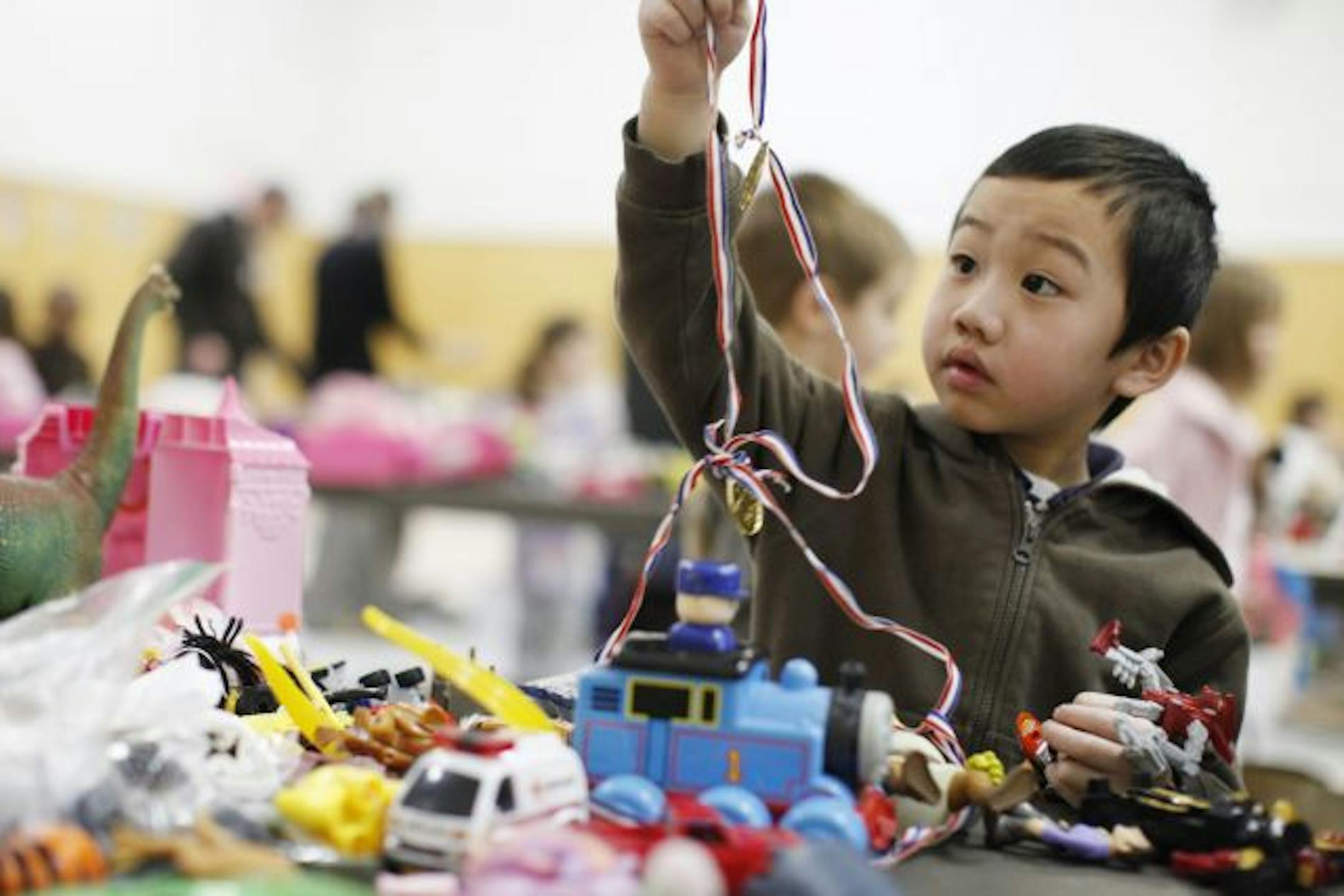 Spontaneous fundraising is breaking out all over the Twin Cities. Take, for instance, the used toy sale at Expo Elementary School in St. Paul on Wednesday. Kindergartner Andrew Xiong, 6, looked over the loot donated by about 700 of his fellow students, who then sold the toys to other students. They made $1,118.