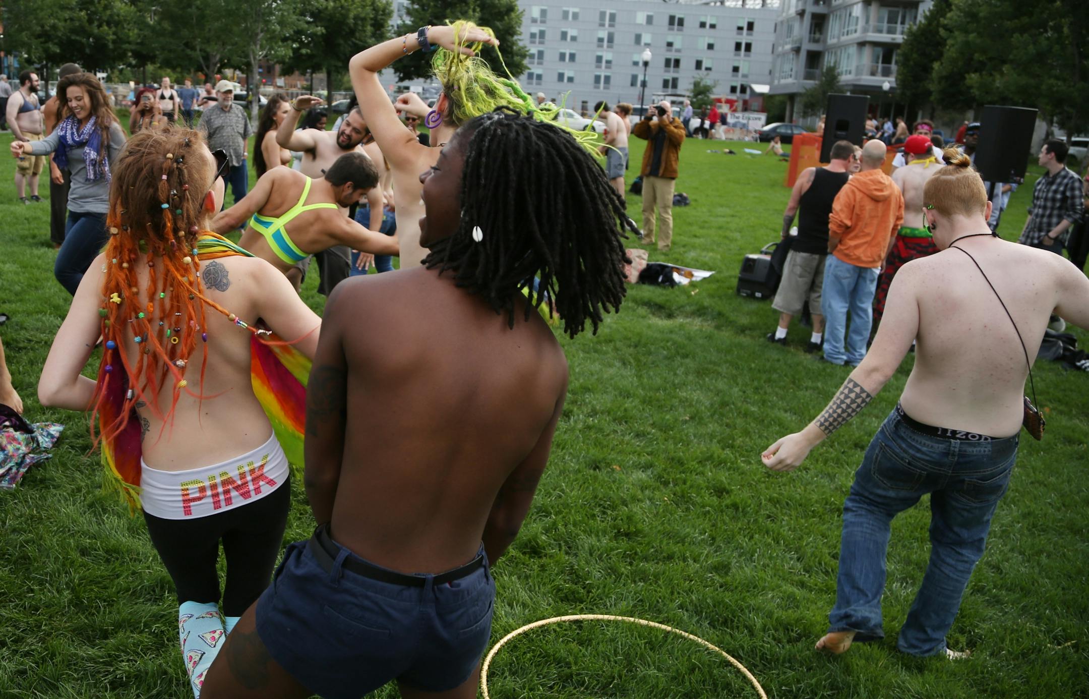Saying it's a matter of gender equity and freedom of expression, topless demonstrators danced at Gold Medal Park Sunday August 23, 2015 in Minneapolis, MN.