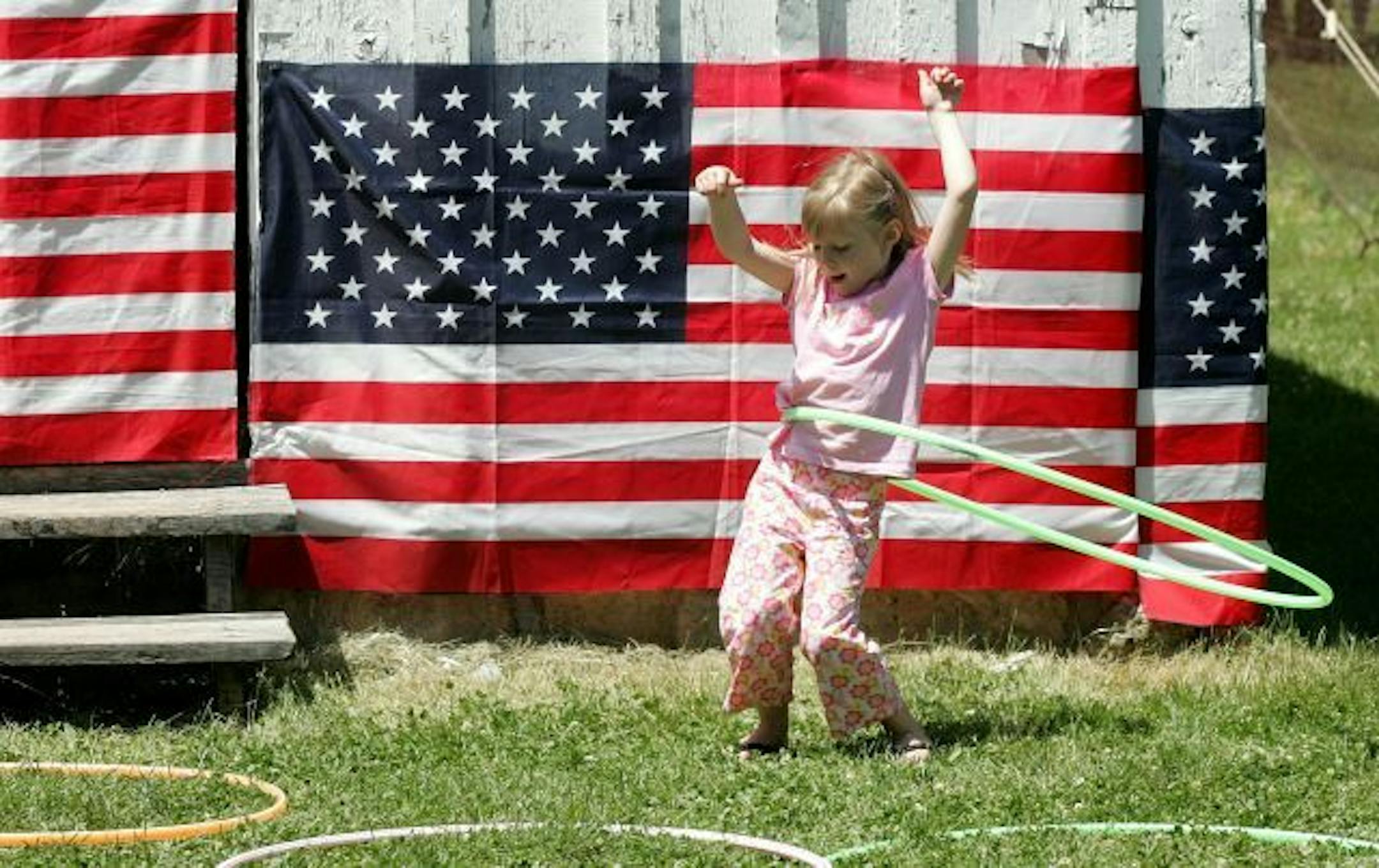 Jenna Field, 4, of Dubuque, Iowa, tries a hula hoop during the 44th annual Mathias Ham House Fourth of July Ice Cream Social Friday, July 4, 2008, in Dubuque, Iowa.
