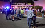 People stand near the entrance on the north side of Crossroads Center shopping mall in St. Cloud, Minn., Saturday, Sept. 17, 2016. Several people were