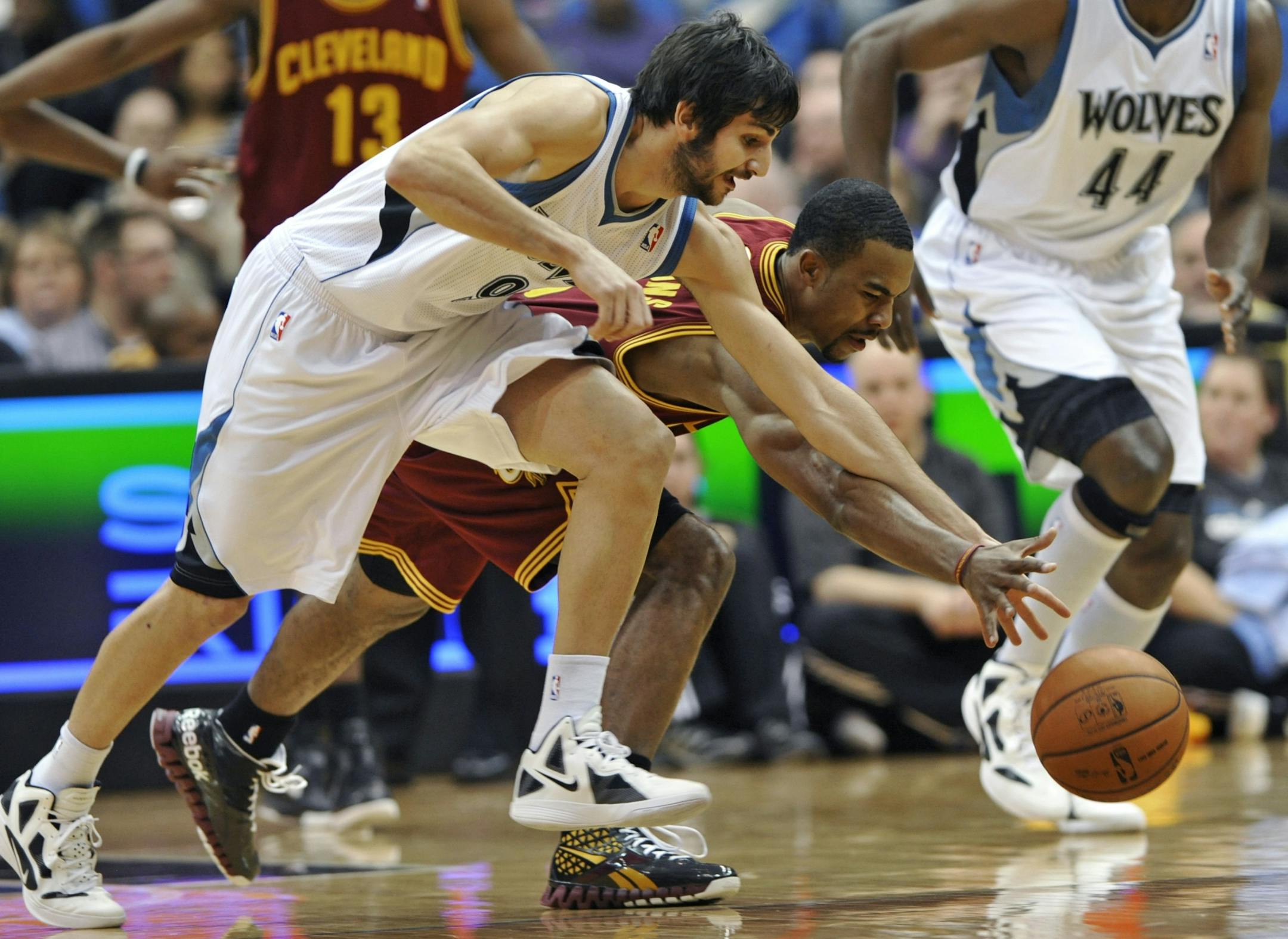 Minnesota Timberwolves' Ricky Rubio, left, of Spain, and Cleveland Cavaliers' Ramon Sessions race for the loose ball in the first half of an NBA basketball game on Friday, Jan. 6, 2012, in Minneapolis.